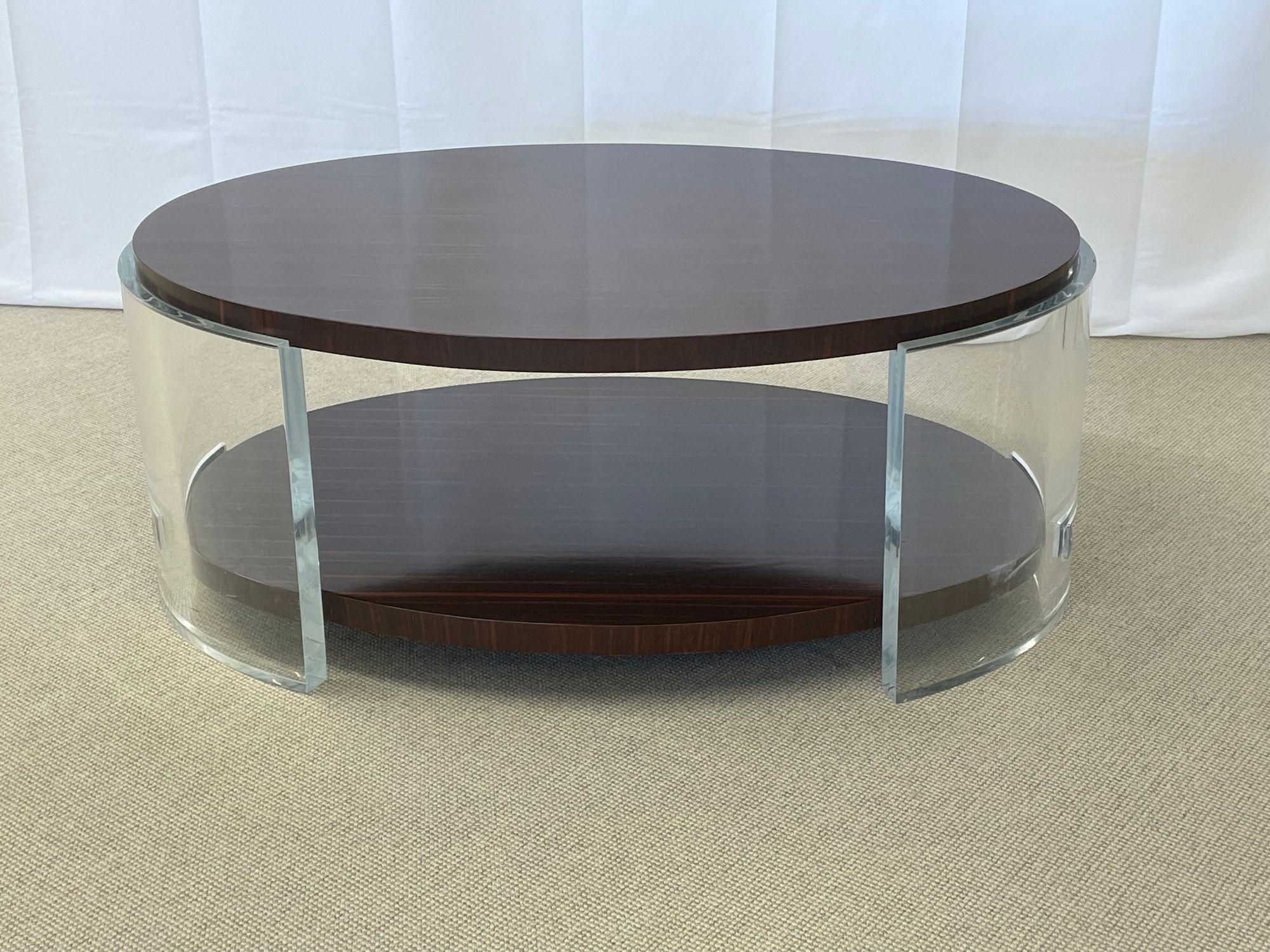 Macassar Ebony Oval Lucite Acrylic Coffee Cocktail Table, Jonathan Franc
 
An impressive cocktail table by Jonathan Franc featuring an elliptical top and lower shelf of highly polished, natural Macassar ebony that are supported by substantive,