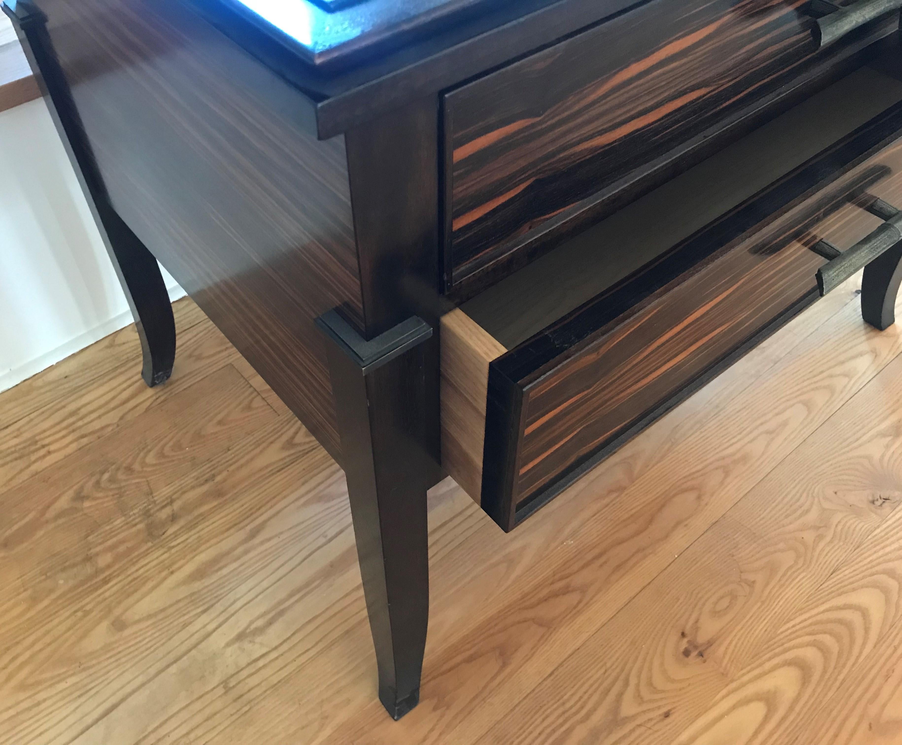 One floor sample in stock now 25% off. 

Macassar ebony side table / chest
This beautiful piece in Maccassar ebony and solid walnut is an oversized side table with two substantial drawers. 

The side table pictured is designed in Macassar ebony with