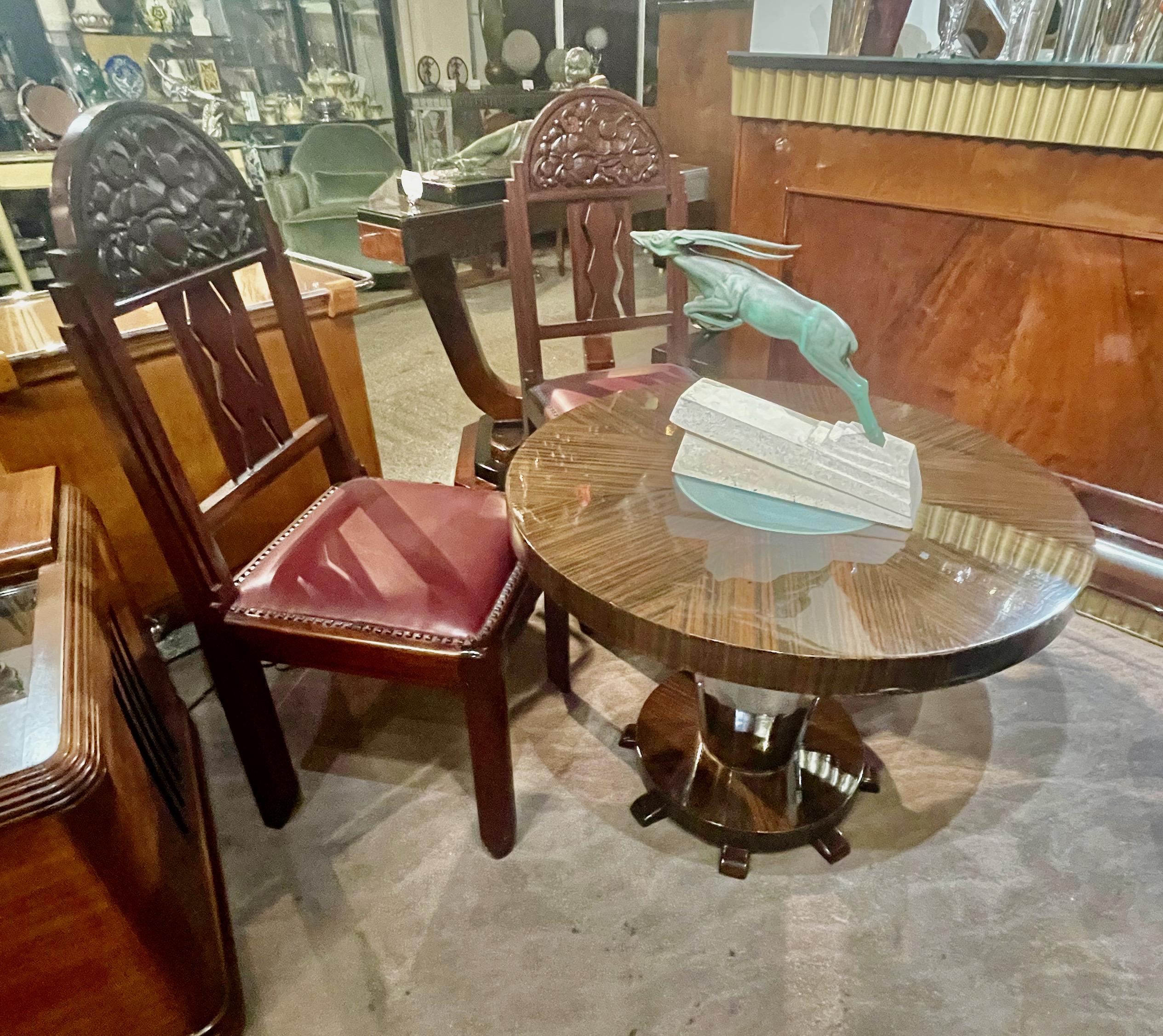 Macassar round Art Deco coffee side table with center light. Special custom table with beautiful Macassar wood designed with thick side skirt and matching floor support. Very unusual faceted metal center, lower base with multiple small support