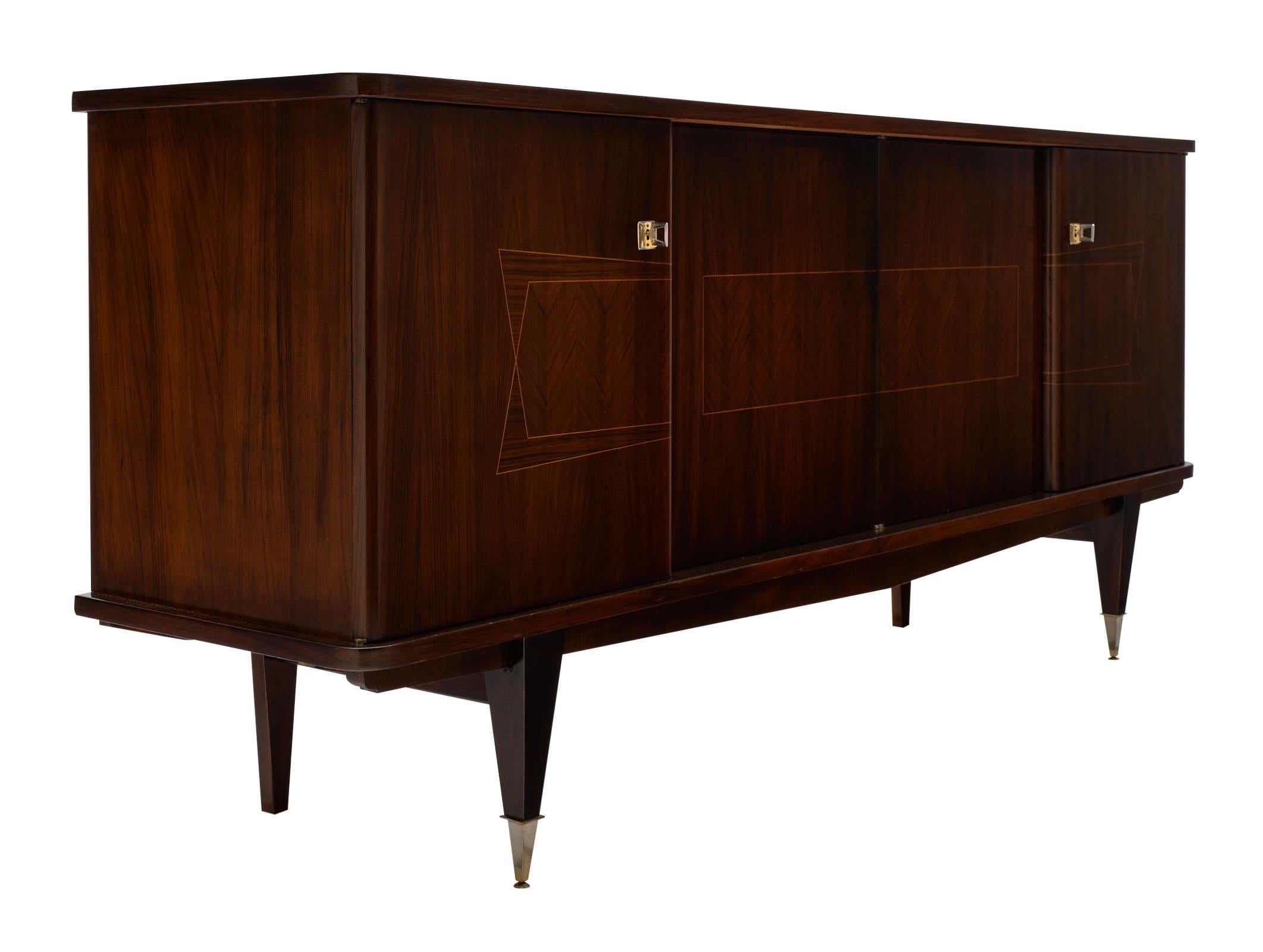 Macassar vintage French buffet with a lustrous high gloss finish. The four doors open up to a lemon wood interior featuring shelves and a drawer. The Macassar exterior has a beautiful midcentury detail across the front of this striking piece. The
