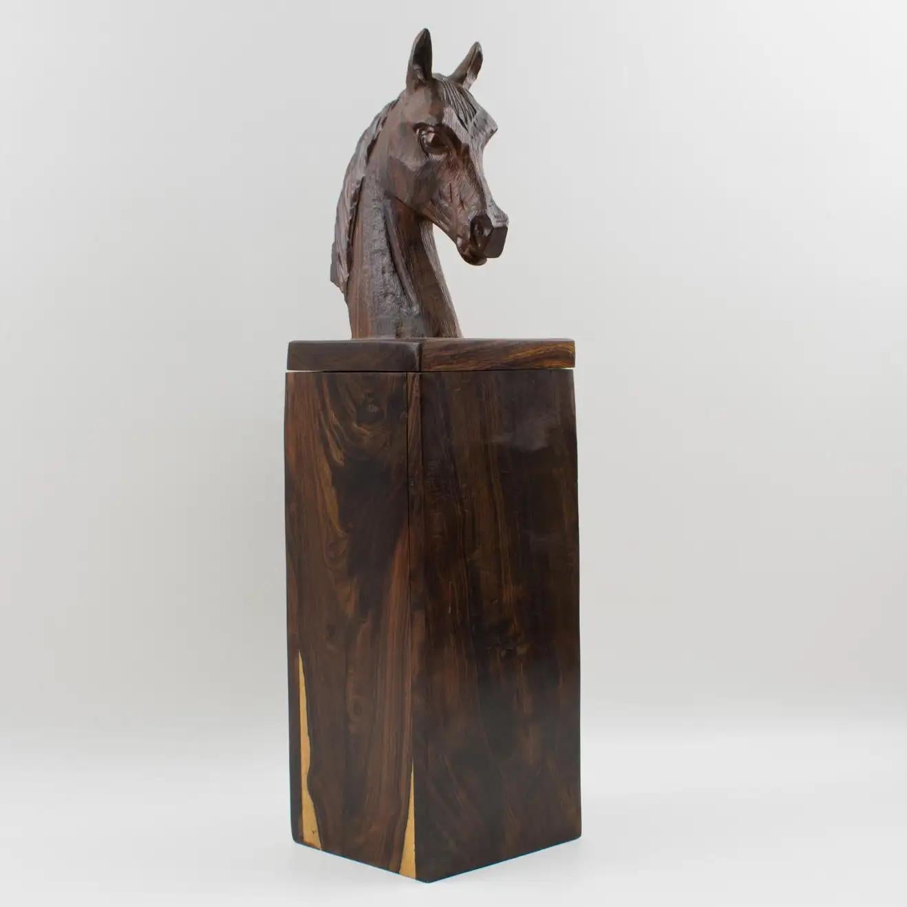 This extra tall decorative lidded box has an incredible hand-carved horse head on the top. The piece features an all-height square shape, made in Macassar wood, handmade and hand-carved. The massive figurative horse head on the top of the lid can be
