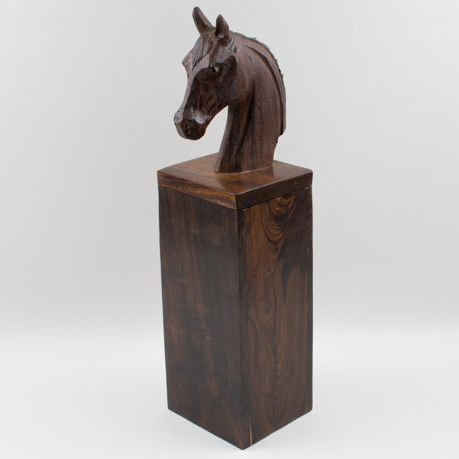This extra tall decorative lidded box has an incredible hand-carved horse head on the top. The piece features an all-height square shape, made in Macassar wood, handmade and hand-carved. The handle is also the massive figurative horse head on the