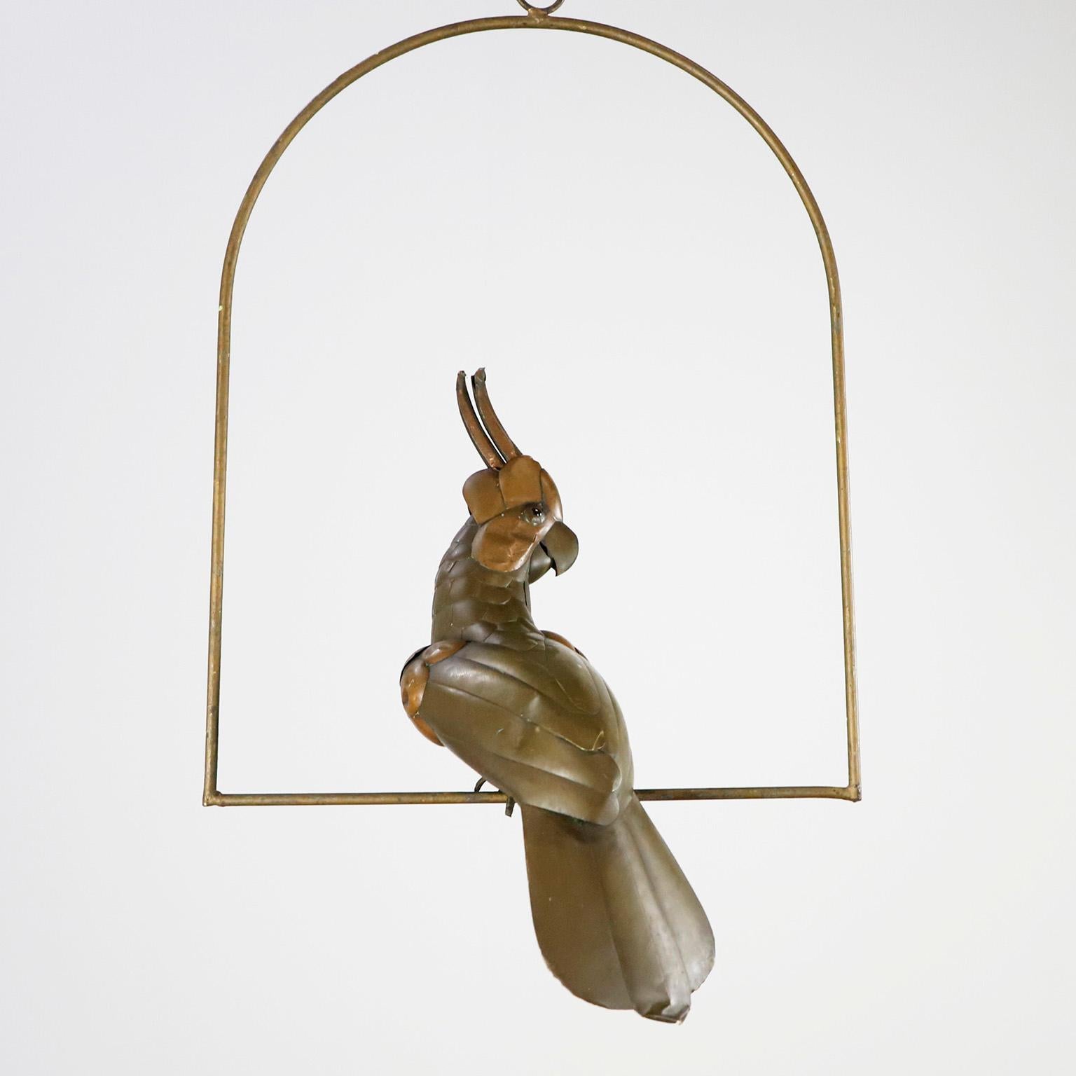 Copper, brass and aluminium Macaw on a hoop hanging stand by Sergio Bustamante, circa 1960. Presents some damages.

Sergio Bustamante is a Mexican Artist and sculptor. He began with paintings and papier mache figures, inaugurating the first exhibit