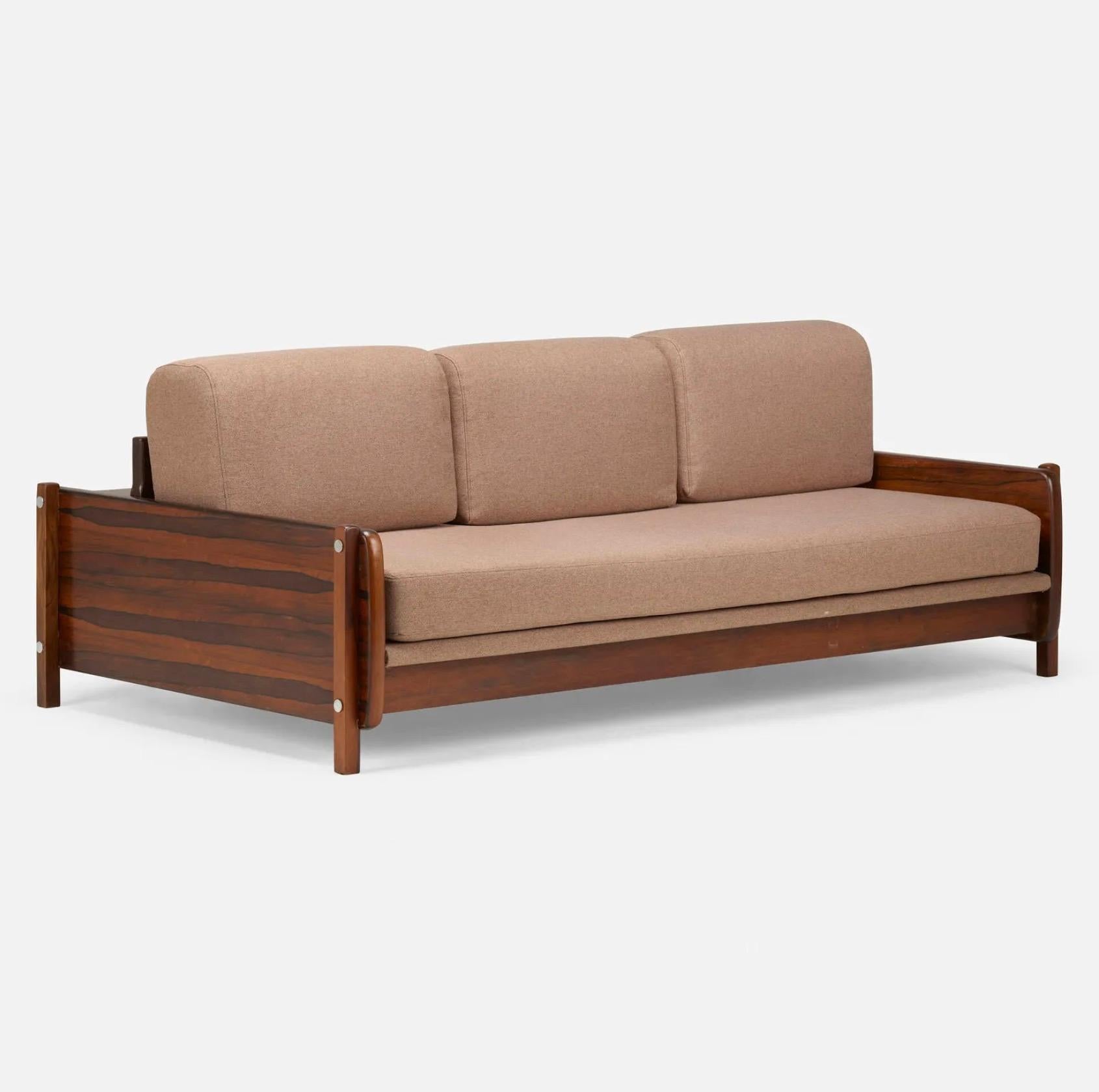 A very rare and very deep 'Macedo' sofa by Sergio Rodrigues which features an integrated storage area on the back. Produced by OCA Brazil in the 1960s, the sofa has an expansive amount of valuable Brazilian Rosewood with deep vivid grain throughout.