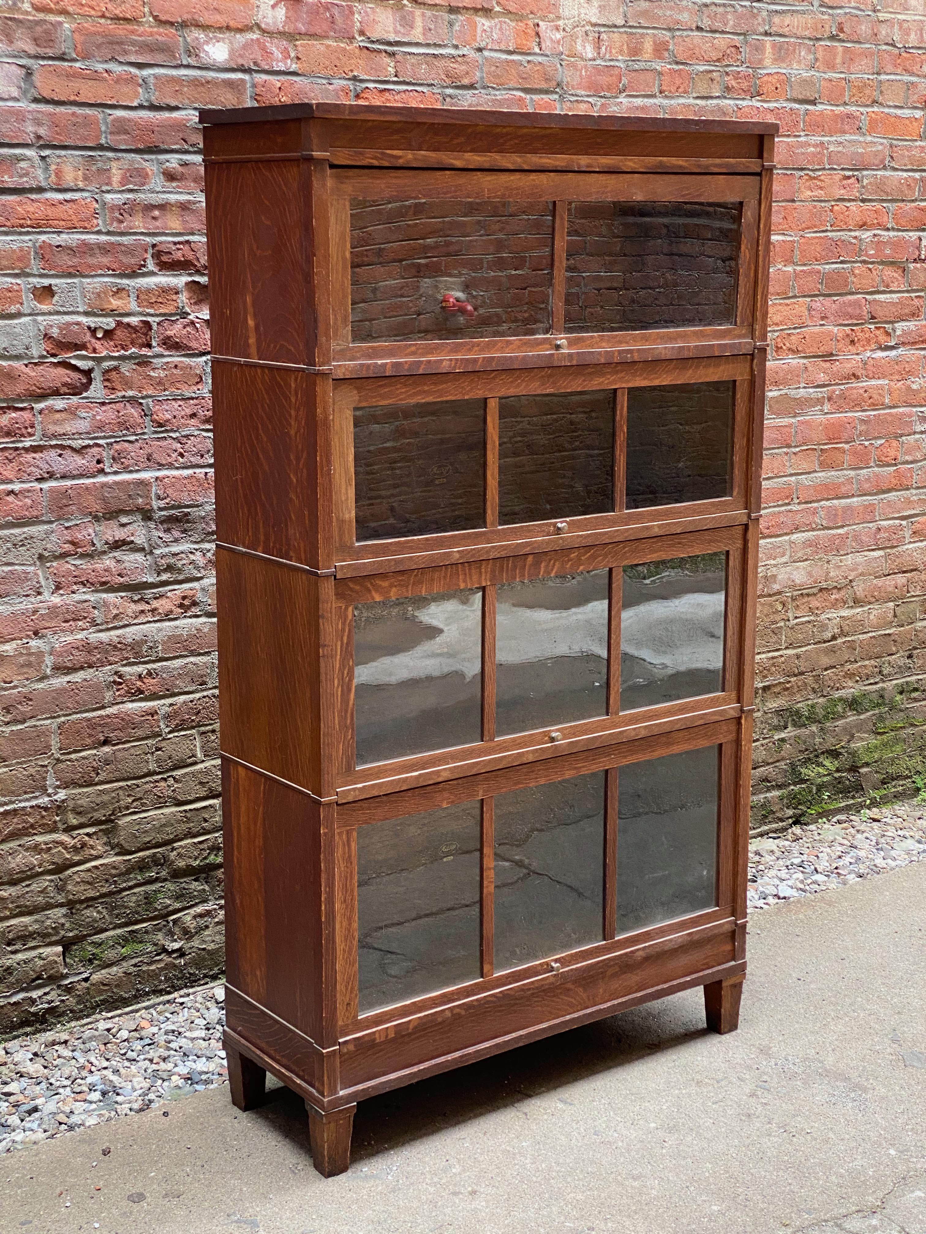 Solid tiger oak Macey four stack barrister bookcase. The set is comprised of a top, tapered footed base, and a 13