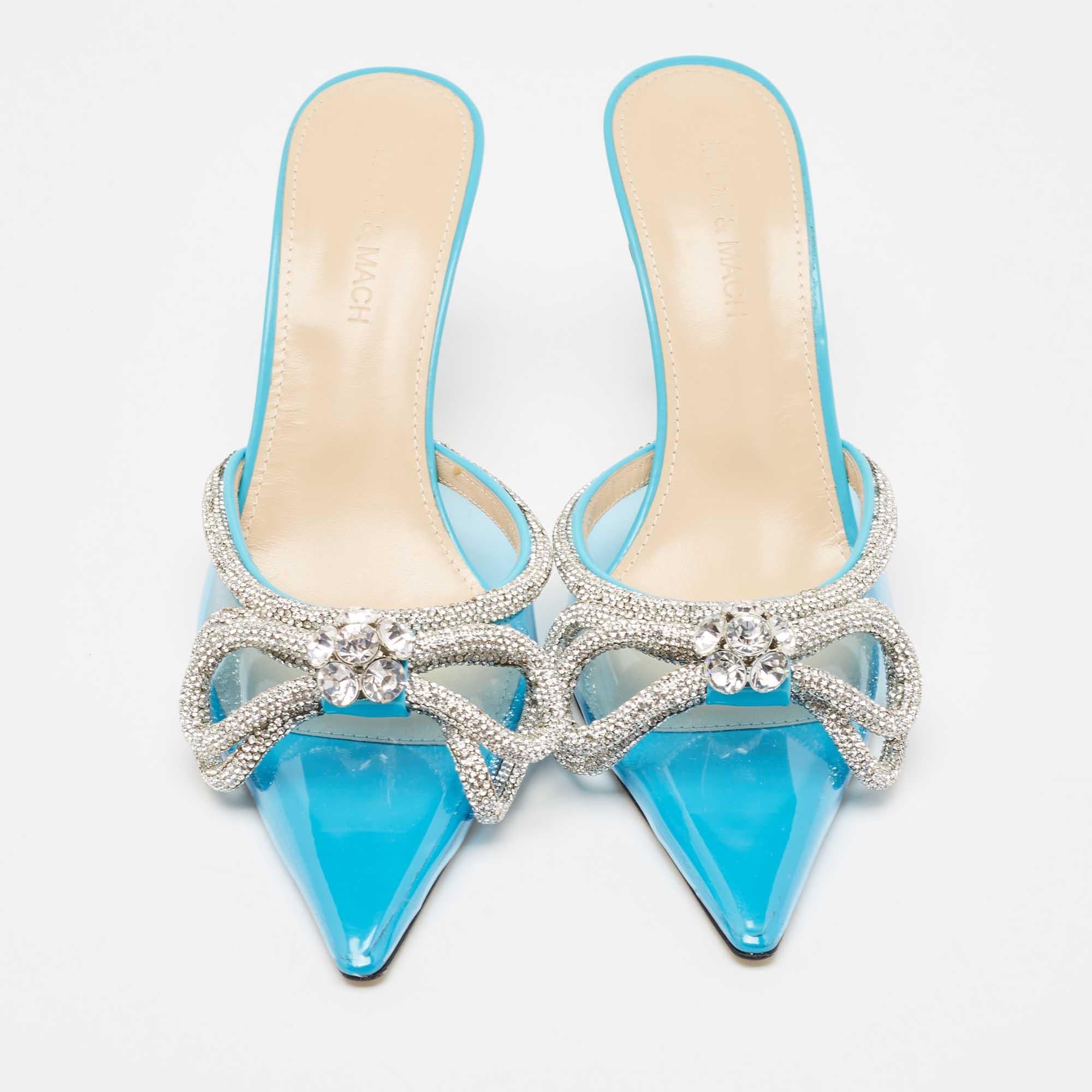 Add these regal Mach & Mach mules to your closet and be glamorously ready for those special parties and events. Constructed from PVC, these pointed-toe pumps feature double bow crystal embellishments on the front, along with low heels and a slip-on