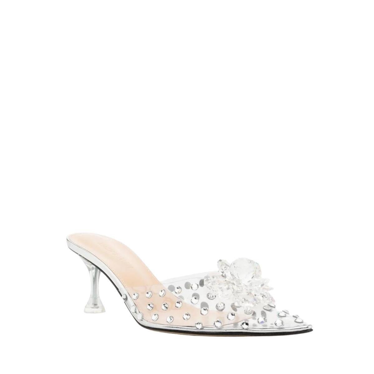 Crystal-embellished transparent mules
Transparent design
Crystal embellishment
Floral detail
Pointed toe
Low heel
Open back
Composition: PVC 100%, silver leather
Sole: Leather 100%
Inner: PVC 100%
Heel: 2.8