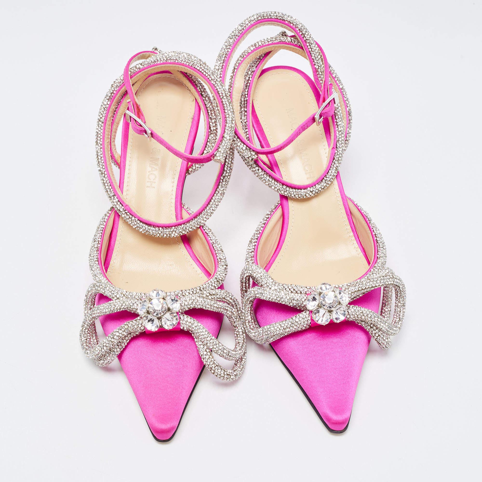 Add these regal Mach & Mach pumps to your closet and be glamorously ready for those special parties and events. Constructed from pink satin, these pointed-toe pumps feature double bow crystal embellishments on the front, along with low heels and