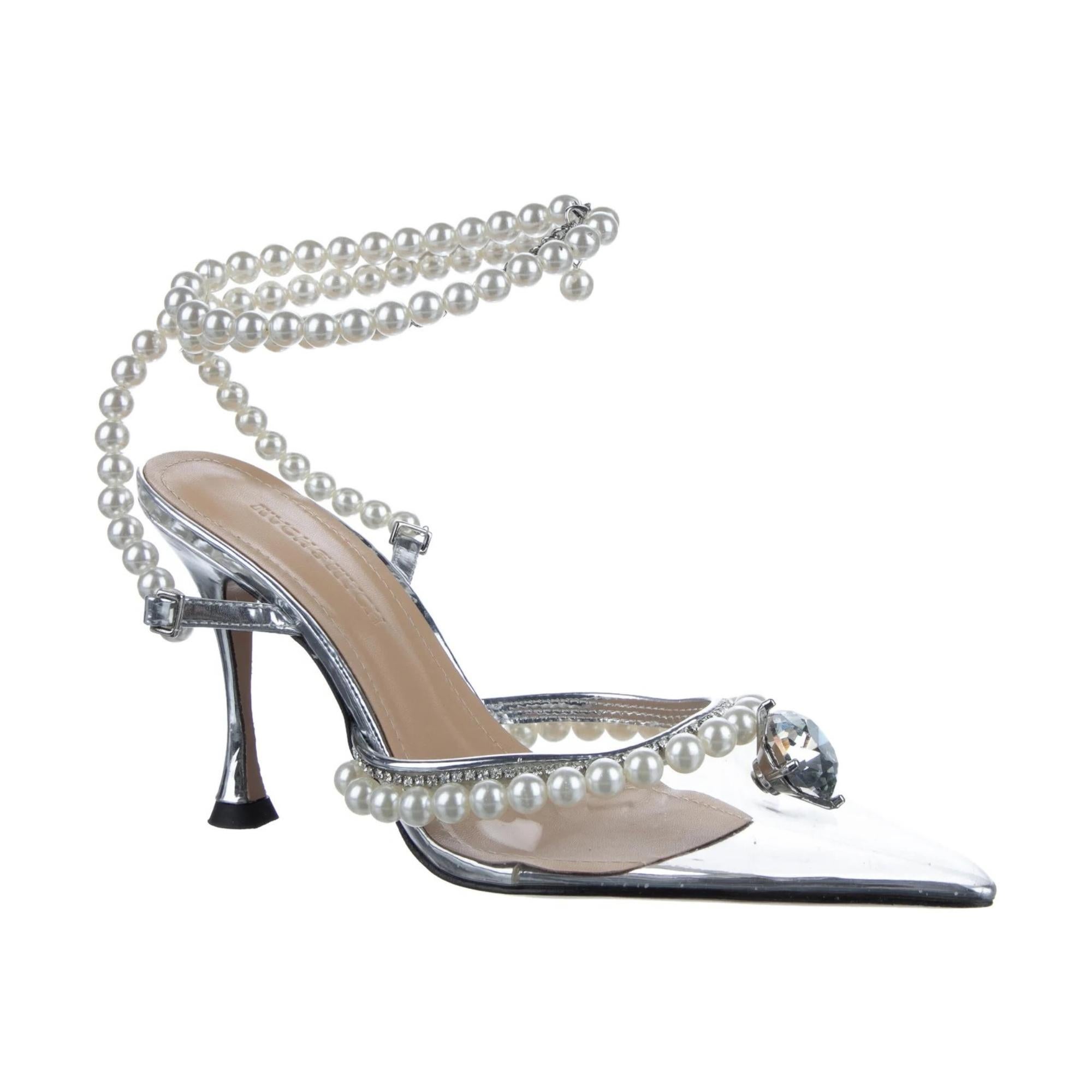 Mach & Mach PVC Slingback Pumps. Silver & Clear. Beaded & Crystal Accents. Pointed-Toes. Block Heels. Wrap-Around Straps & Buckle Closure at Ankles.

COLOR: Silver & Clear
MATERIAL: PVC, strass
SIZE: 8 US
HEEL HEIGHT: 110 mm / 4.25”
CONDITION: Very