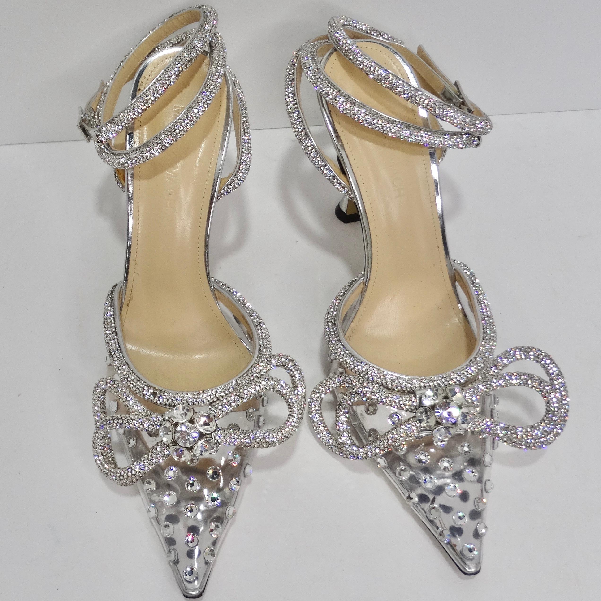 Introducing the epitome of elegance and glamour: the Mach & Mach Silver Double Bow 100 Crystal PVC Pumps. Crafted with precision and passion in Italy, these stunning shoes are a testament to luxury and sophistication. Meticulously designed and