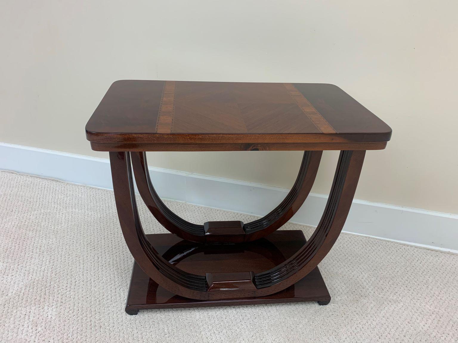 Extraordinarily beautiful Art Deco end table. The top inlays consist of burl walnut and zebrawood / walnut. The top is supported by an elegantly curving streamline base. Restored to mint condition. Dimensions: 14 inches wide, 24 inches long and 21.5