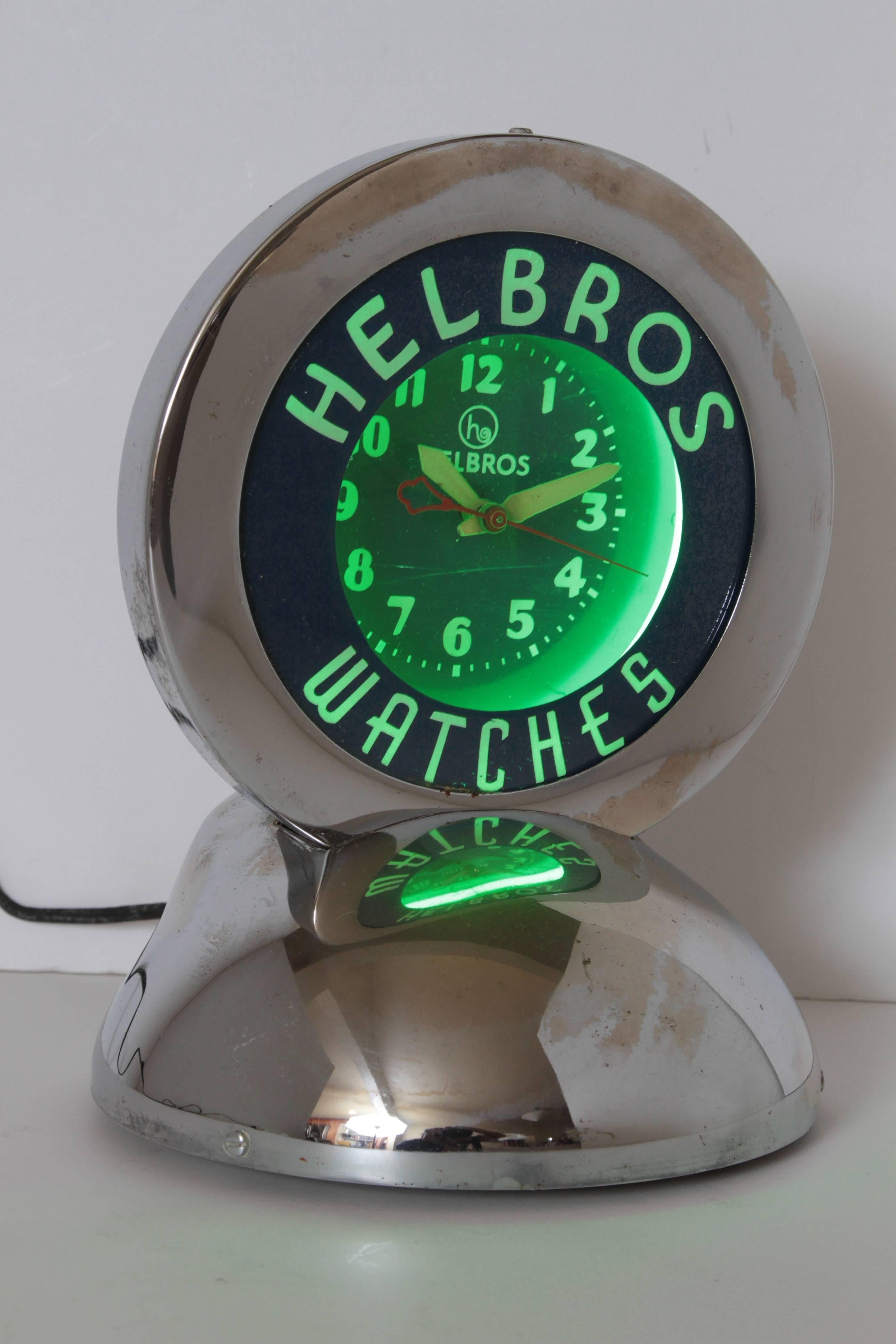 Machine Age Art Deco chrome and neon helbros advertising clock by Glo Dial

Rare original Helbros example, in working condition. 
All original; with Classic Glo Dial green neon, reverse painted glass, chromed case.
Self-contained tabletop
