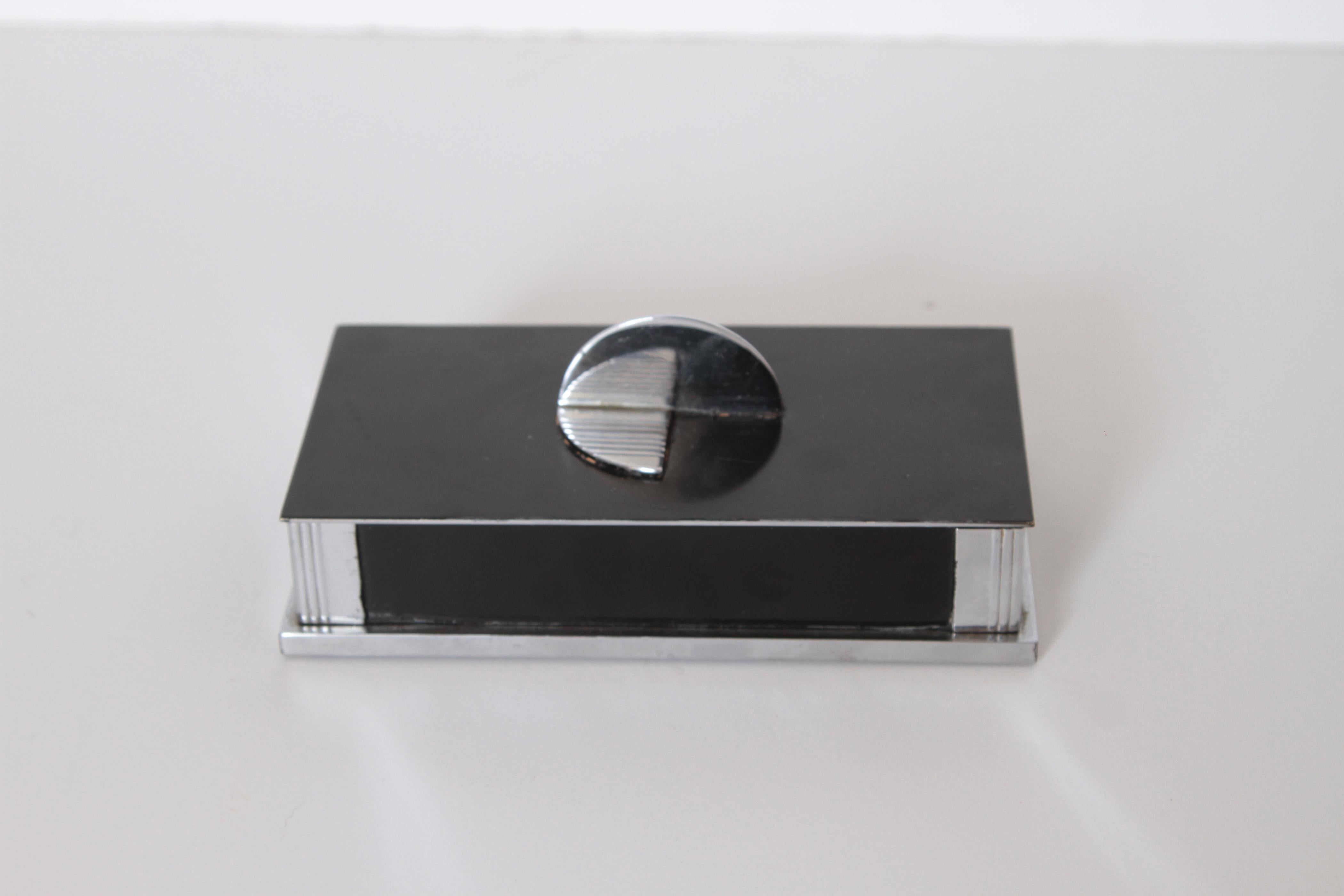 Machine Age Art Deco cubist hinged box in chrome / black enamel, Cedar, lined.
Nicely designed vintage cigarette, jewelry or occasional box. Signed LaPierre 1237
appealing form similar to some of the early Ronson Designs. Incised lines to several