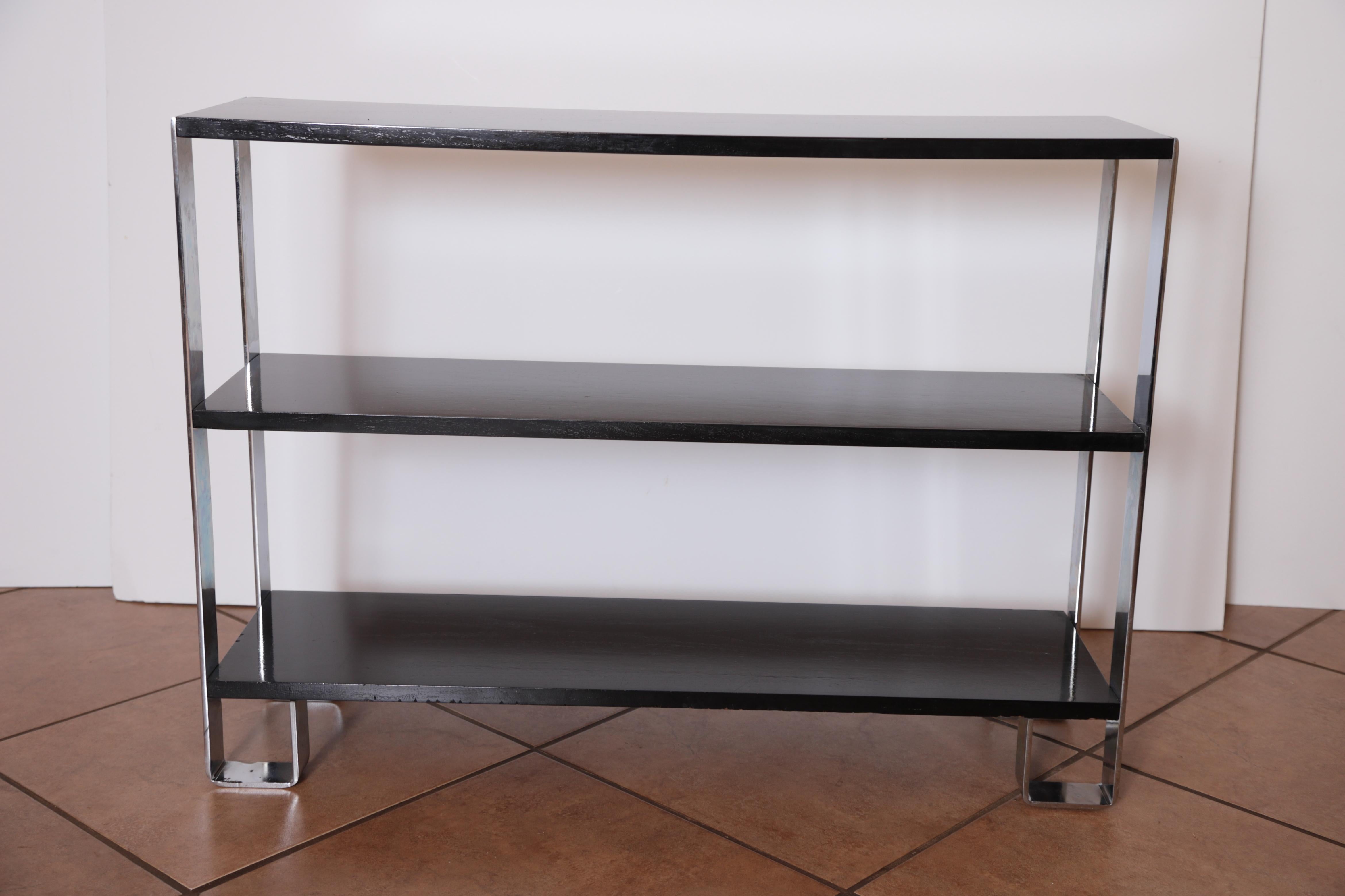 Machine Age Art Deco flat - band chrome / Black lacquer shelf, in the manner of Donald Deskey
bookcase entertainment center shelves console sofa table.

A nicely restored example of rectilinear modernist design, in the manner of Deskey and