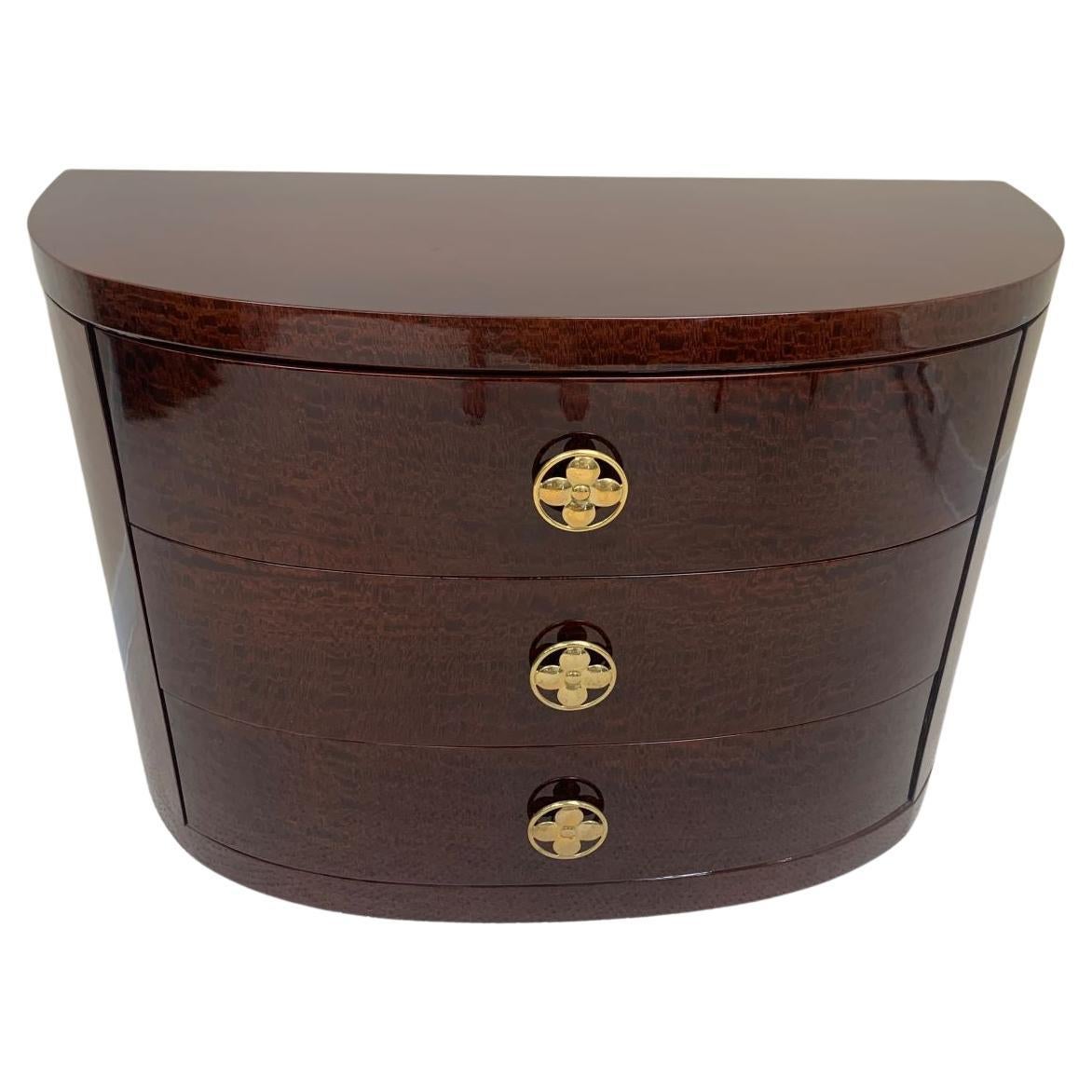 Beautiful Art Deco half circle chest of drawers by the Redlion Furniture Company for Modernage Furniture Co. New York, New York. Incredible brass handles in a circular shape with a flower center and gorgeous patina. It’s difficult to find a half