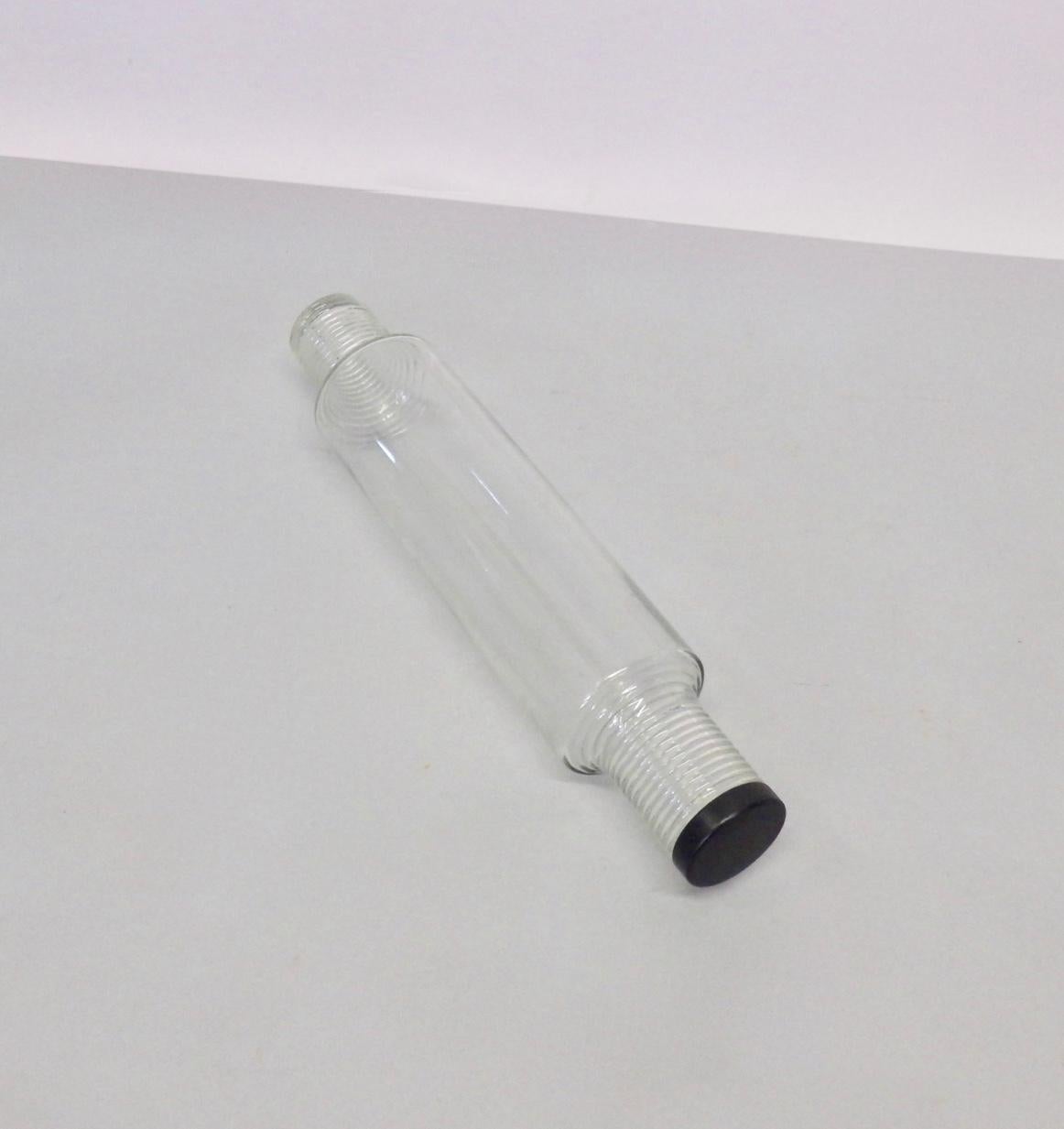 Machine age glass rolling pin with screw on metal end cap.