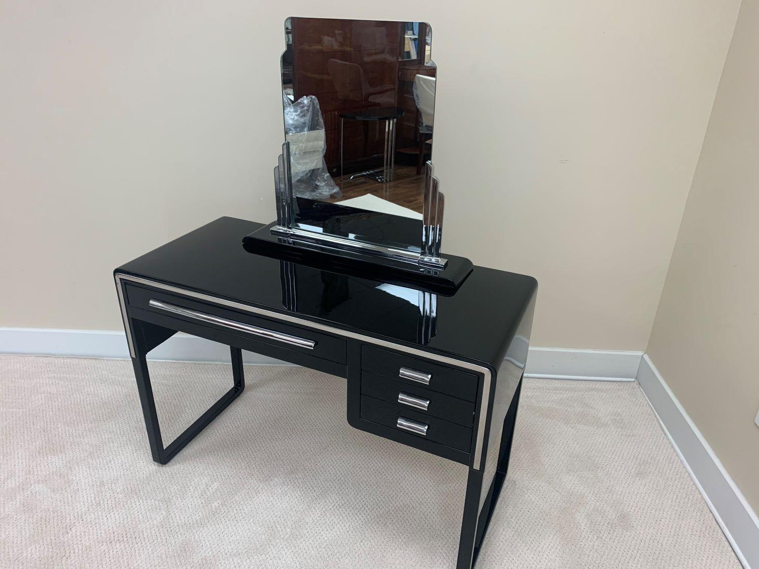 Very rare Art Deco Norman Bel Geddes desk or vanity and Skyscraper mirror by Simmons, circa 1930. Marked on bottom of the mirror and cabinet 5-33. The mirror design is based off the Chrysler building in NYC. It also was on display at Chicago’s