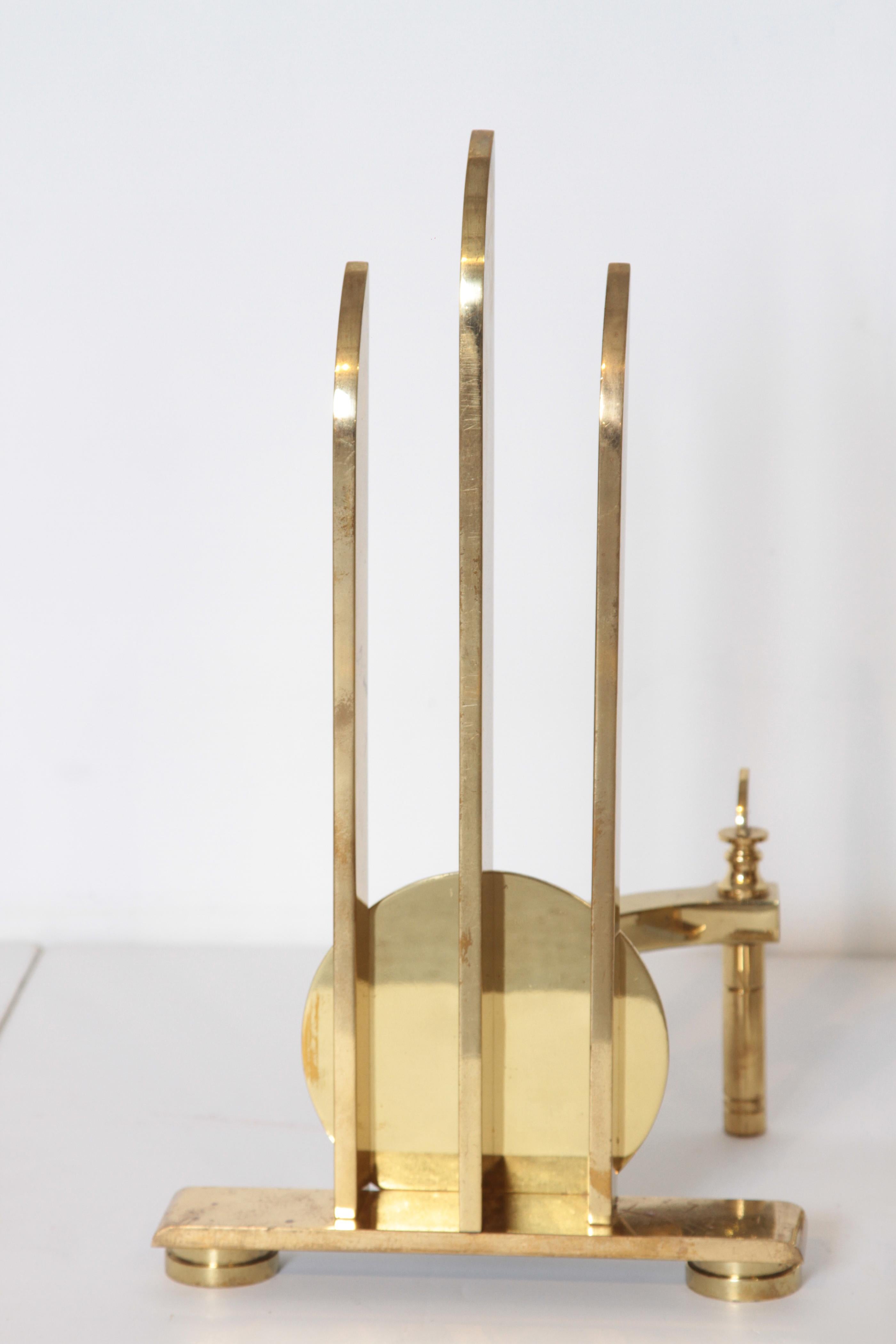 Machine Age Art Deco streamline andirons, in the manner of Walter Von Nessen.

Unparalleled solid brass Industrial Design construction, extreme heft.
A design much in the manner of Walter Von Nessen, if you are familiar with his chase 