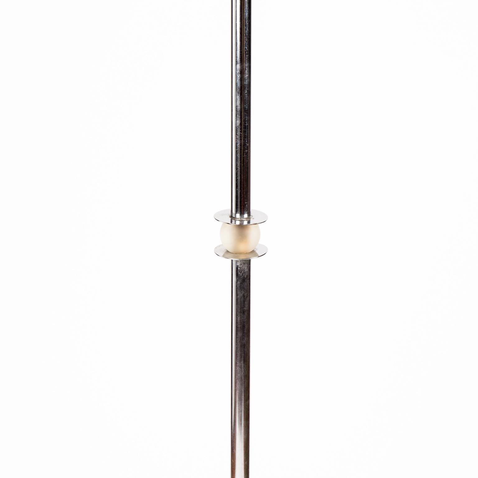 Machine age chrome floor lamp with beautiful detailing including glass insert and chrome speed rings throughout. Very heavy...Probably used in a commercial setting. A stand alone piece that would add charm and chic to any setting.


