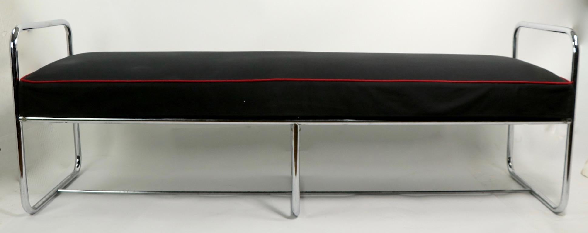 Rare Machine Age bench designed by Wolfgang Hoffman, having a tubular chrome base and upholstered pad seat. This example is in very good condition, clean and ready to use. The seat has probably been reupholstered, currently in skirted black fabric