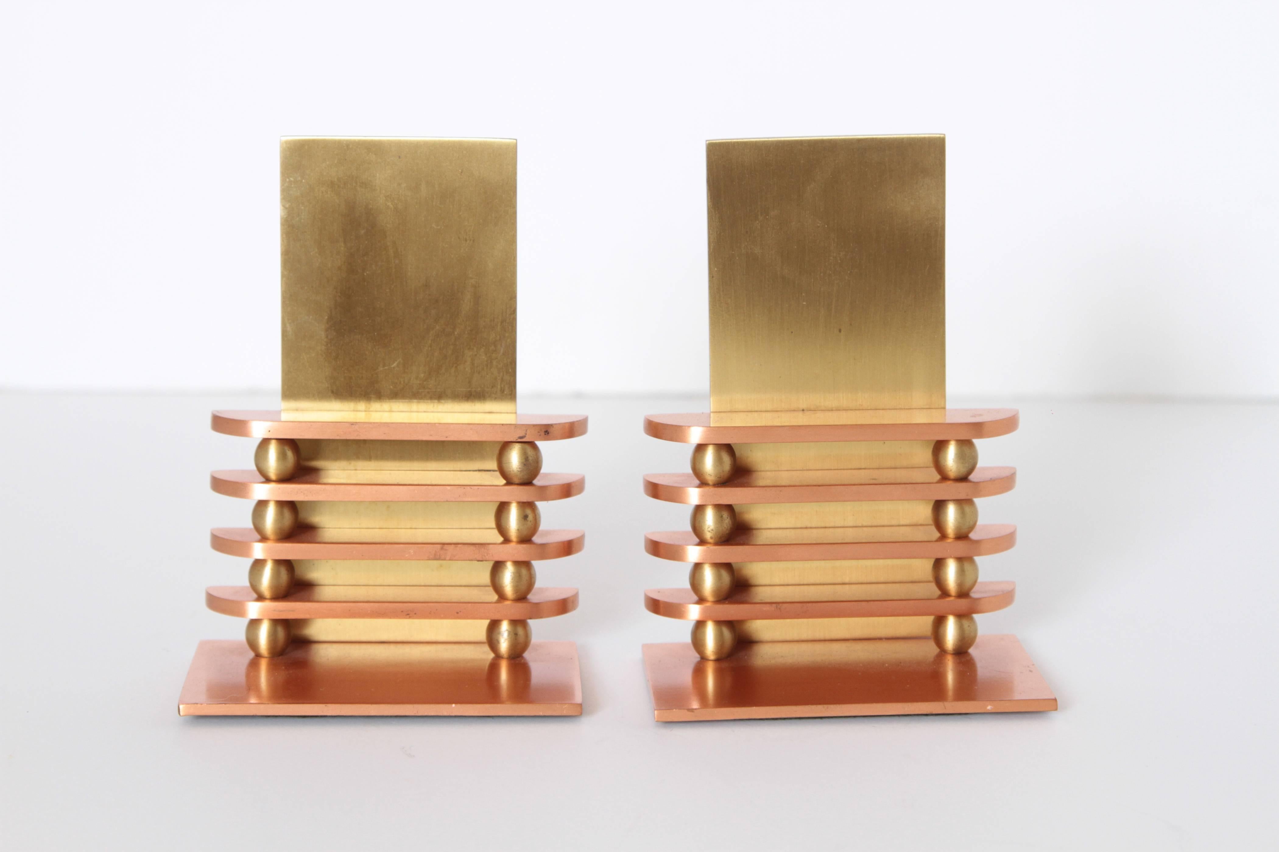 Machine Age Art Deco Walter Von Nessen octaball bookends for Chase, pair

A rare early limited-production Nessen design for Chase, produced only in 1933.
Appealing polished copper / polished brass finish. 
Catalog # 17041.
Much more difficult to
