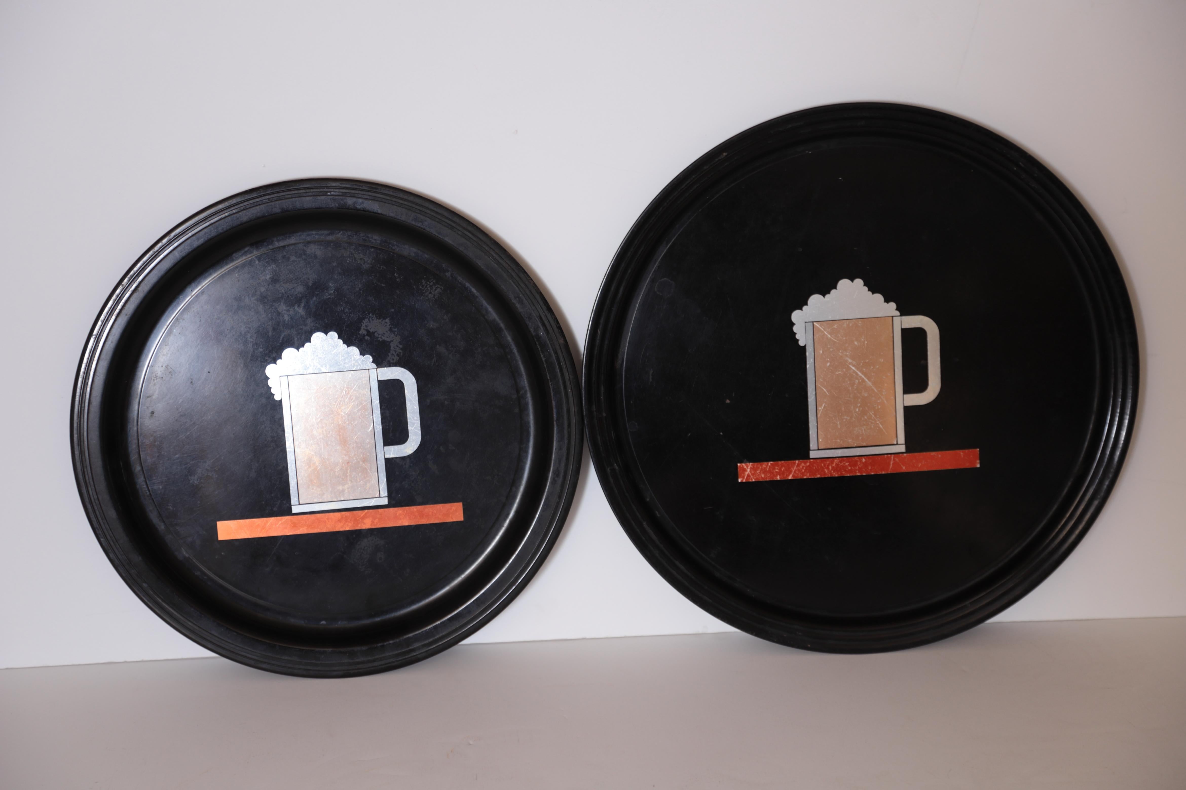 Machine Age Art Deco Westinghouse Micarta and Anodized aluminum beer trays pair

Likely the rarest of the Iconic inlaid Micarta Trays, rarely seen examples in two large sizes: 15 inch and 13.5 inch diameters.
Unknown George Switzer or Donald