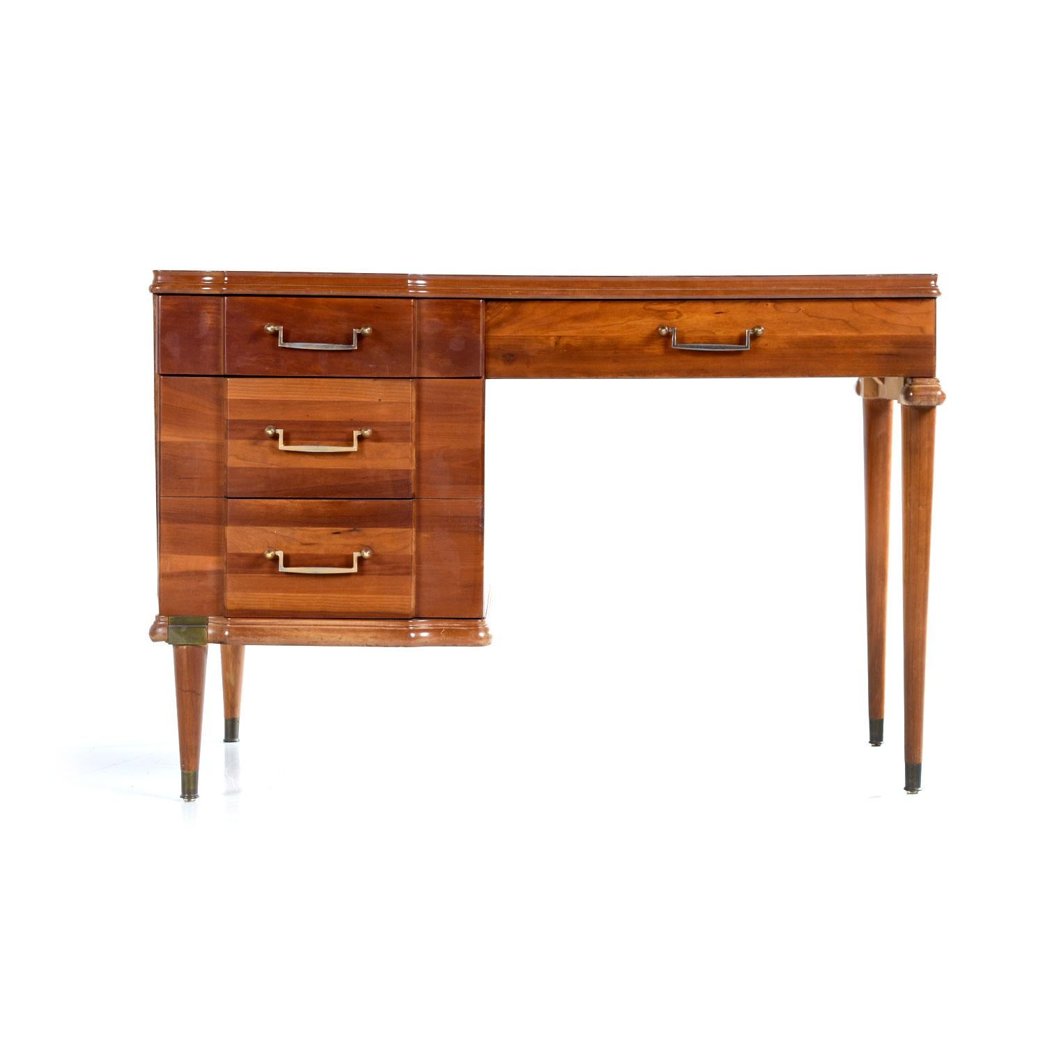 Made by Hickory Manufacturing Furniture Company, this cherrywood desk is an interesting hybrid of many styles. The machine age pulls, Campaign brass accents and Art Deco bump-outs make it tough to categorize the exact look. Regardless, it’s a pretty