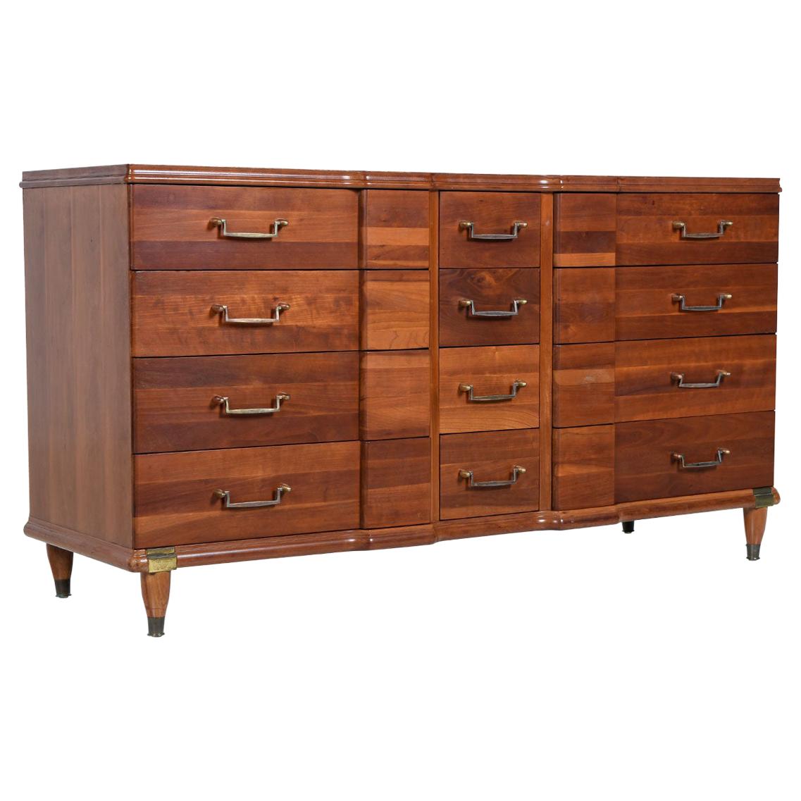 Made by Hickory Manufacturing Furniture Company, this cherrywood dresser is an interesting hybrid of many styles. The Machine Age pulls, Campaign brass accents and Art Deco bump-outs make it tough to categorize the exact look. Regardless, it’s a