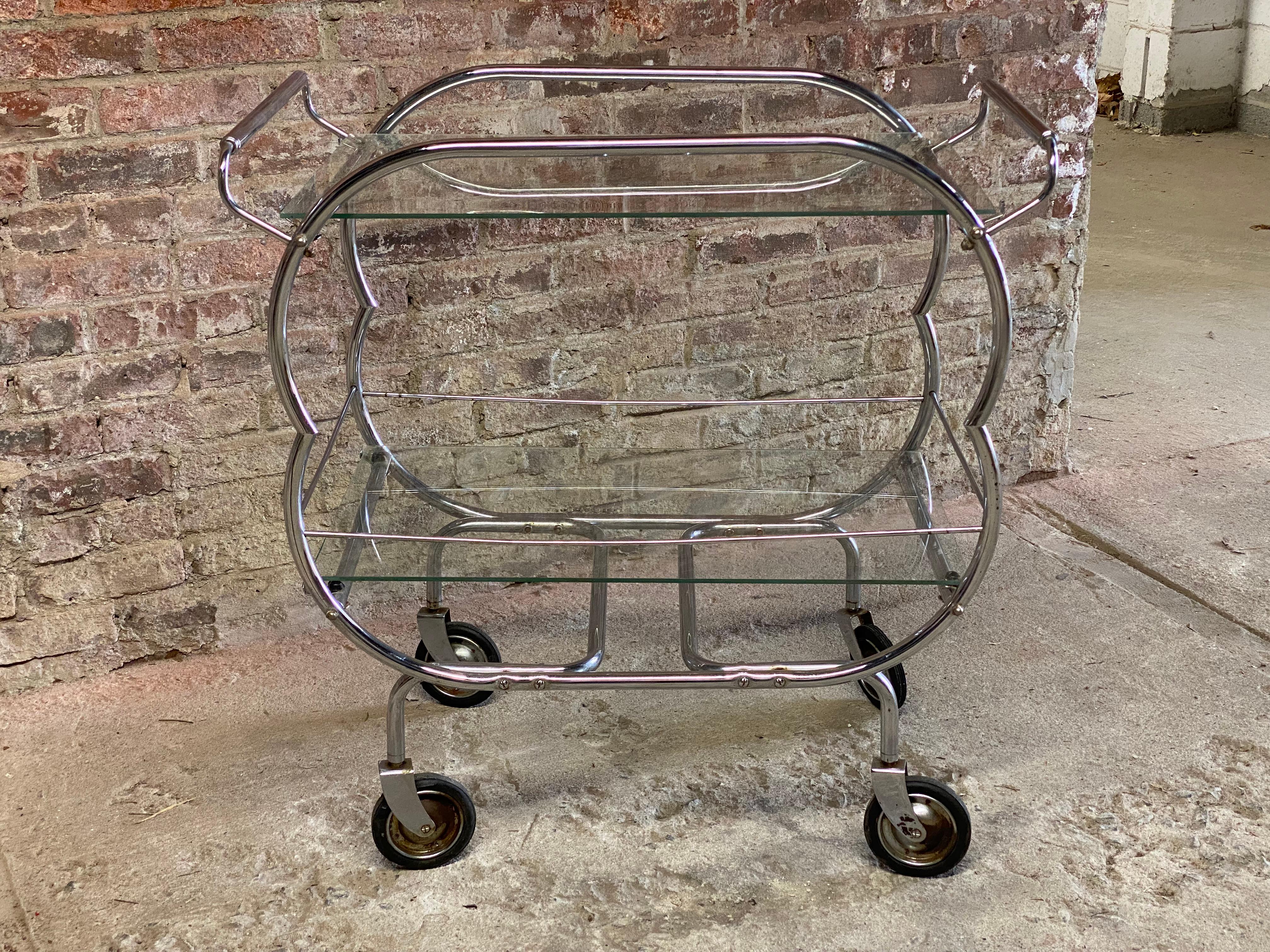 Excellent tubular chrome with glass shelves bar cart. Hard rubber wheels. Curvy bright chrome structure with two glass shelves. Circa 1920-30. Good overall condition with some light rusting and pitting. Structurally sound and sturdy. Some small