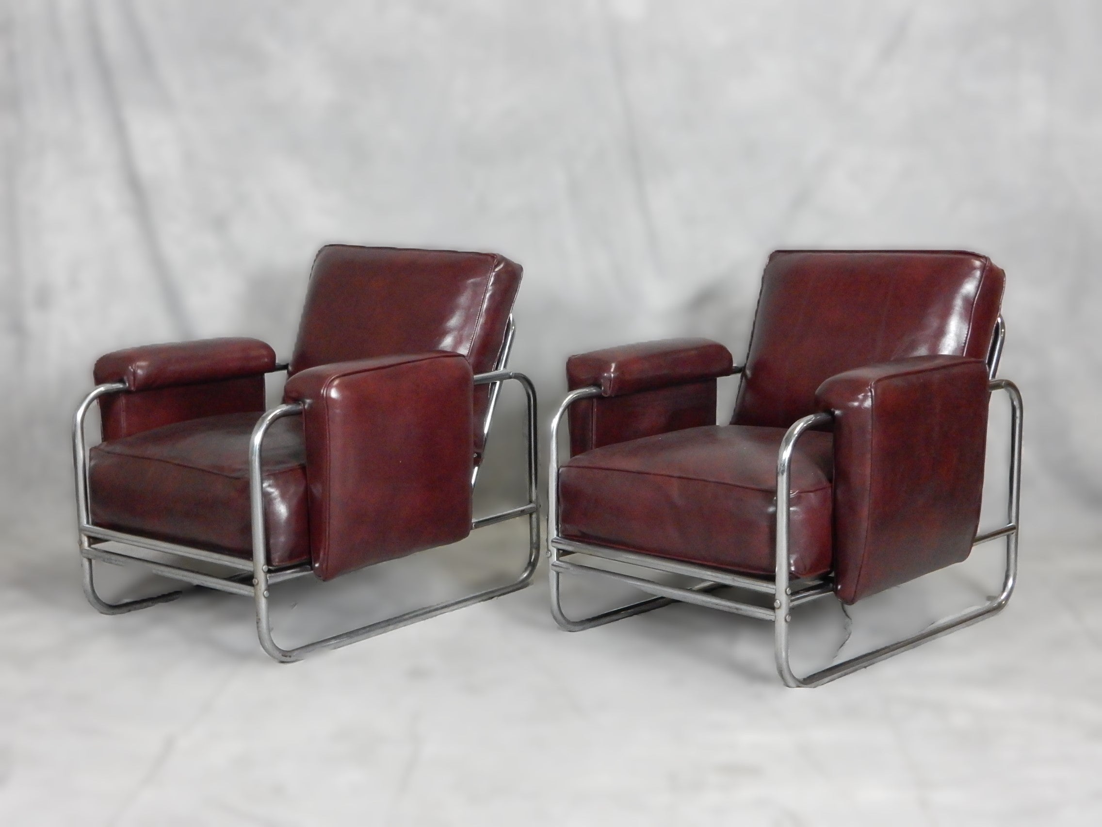 Nickel plated tubular steel lounge chairs with large Naugahyde upholstered cushions. These are built like tanks and extremely comfortable.
Upholstery and inner springs are in excellent condition. 
Frames are solid but do show pitting and rust in