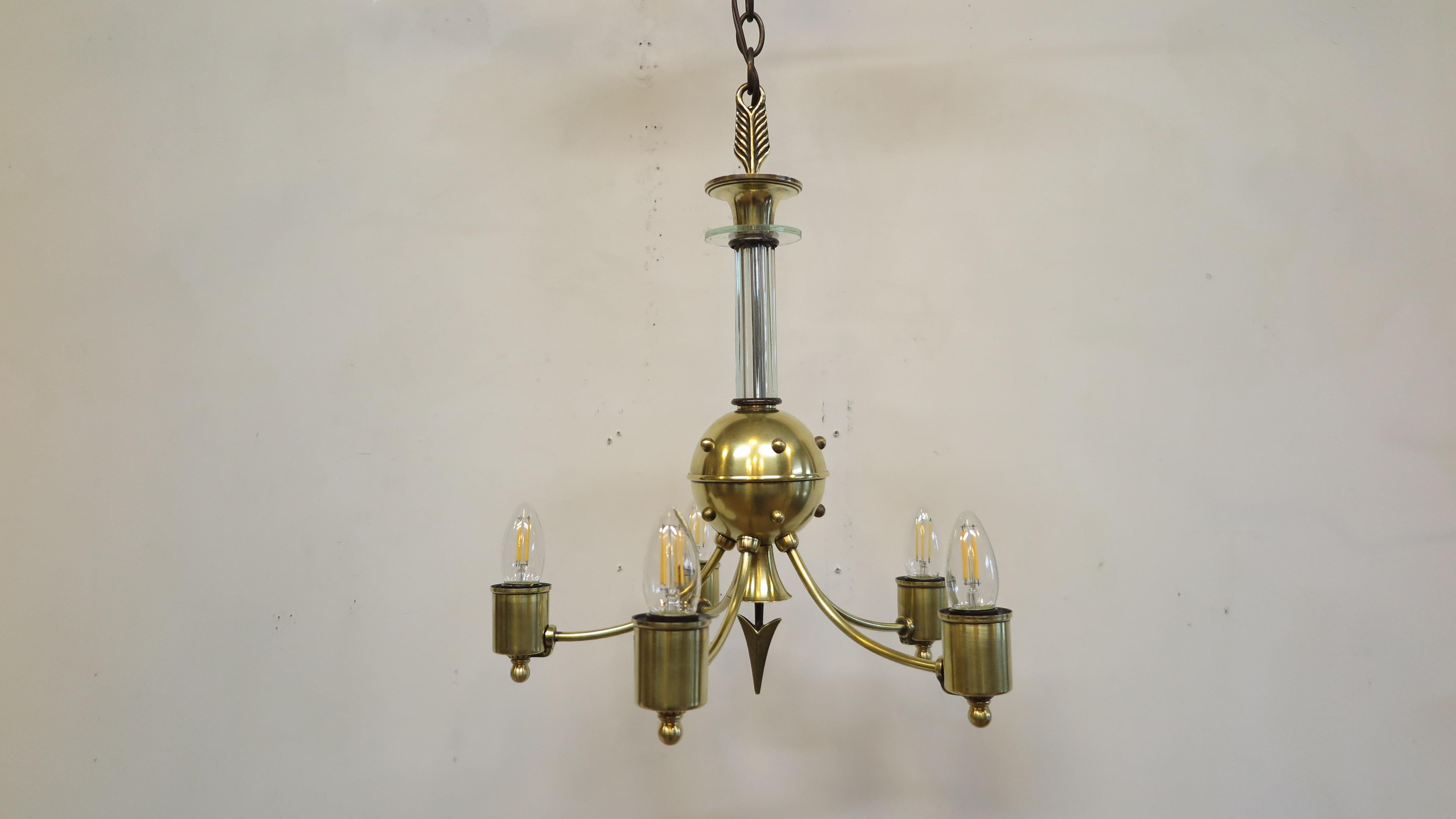 An American Brass Machine Age / Mid Century chandelier. Machine age Mid Century chandelier with Atomic styling by Globe Lighting Fixture Mfg. Co. Made in America. A fantastic find of a rarely seen design with an Atomic motif make this a uniquely