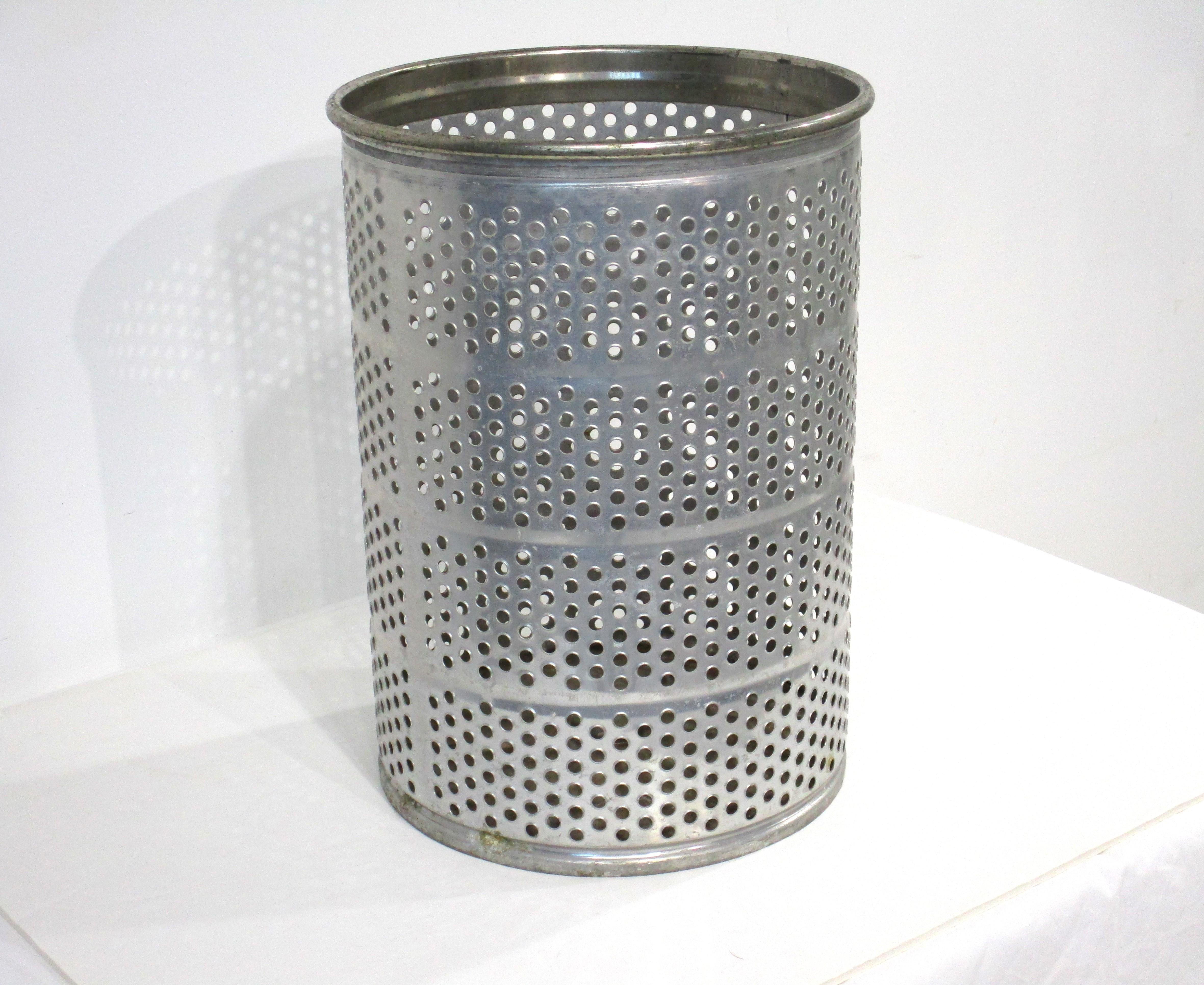 A very well crafted perforated Machine Age / Art Deco metal wastebasket with smooth beaded top edge and bottom . Marking to the side edge 10-36 date made or model number the manufacture unknown . Perfect for your desk , office or a bathroom designed