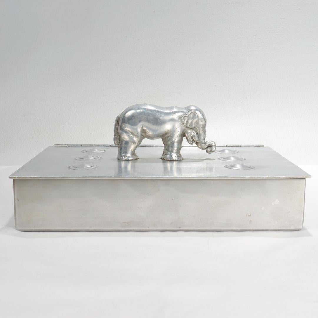 A fine signed midcentury aluminum table box.

By Palmer Smith.

With a full figural elephant handle of finial to the lid.

Model no. 211.

Possibly also designed as a humidor.

Simply a great Machine Age box!

Date:
Mid-20th