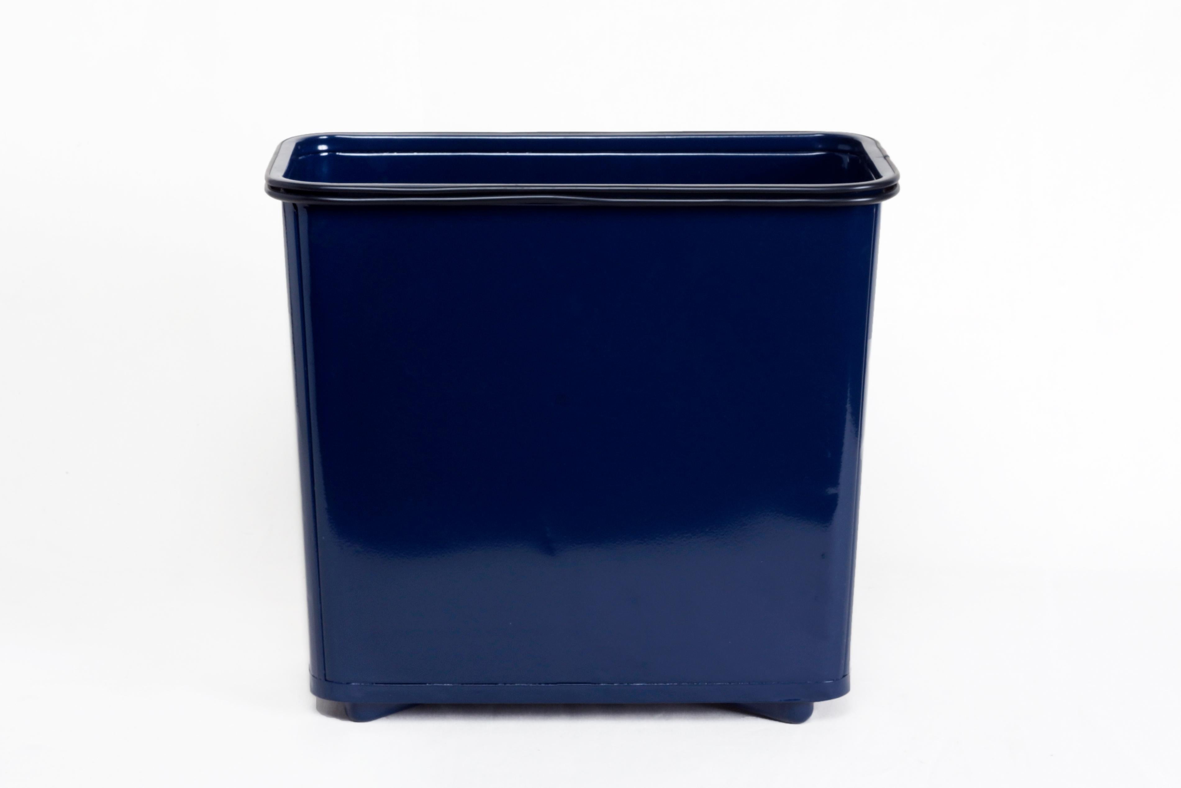 Excellent 1940s steel trash can refinished with a gloss midnight blue powder coat. Uncommon slender rectangular shape with rubber trim and steel feet that lift it slightly off the ground. Please note gentle dents to vintage steel as pictured.