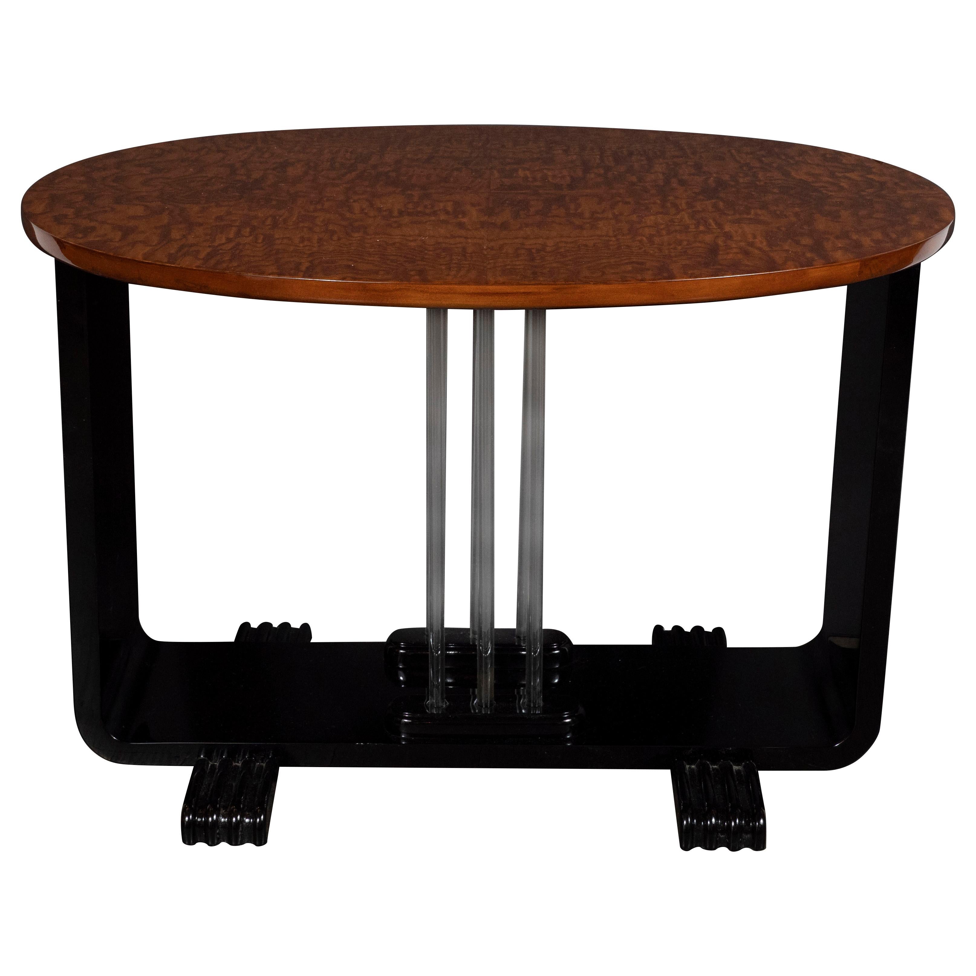 This refined Machine Age Art Deco side table was realized in the United States, circa 1935. It features an oval burled elm top offering a stunning grain; and a U-Form composed of two black lacquer streamlined supports that sit on reeded streamlined