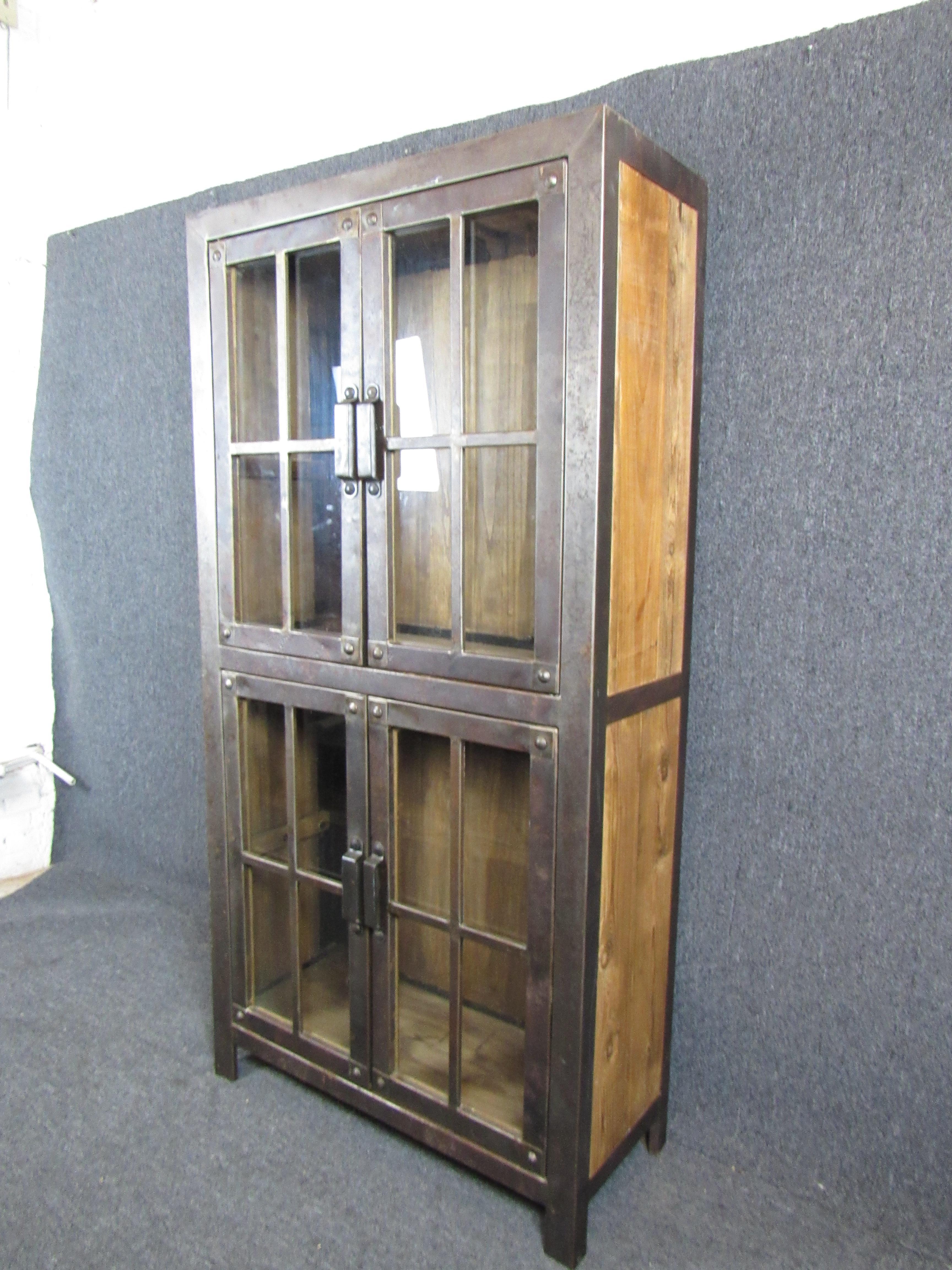 Industrial cabinet made from reclaimed iron and lumber. Glass doors with iron trim, accented by large exposed rivets. Great for kitchen or living room storage.

(Please confirm item location - NY or NJ - with dealer).