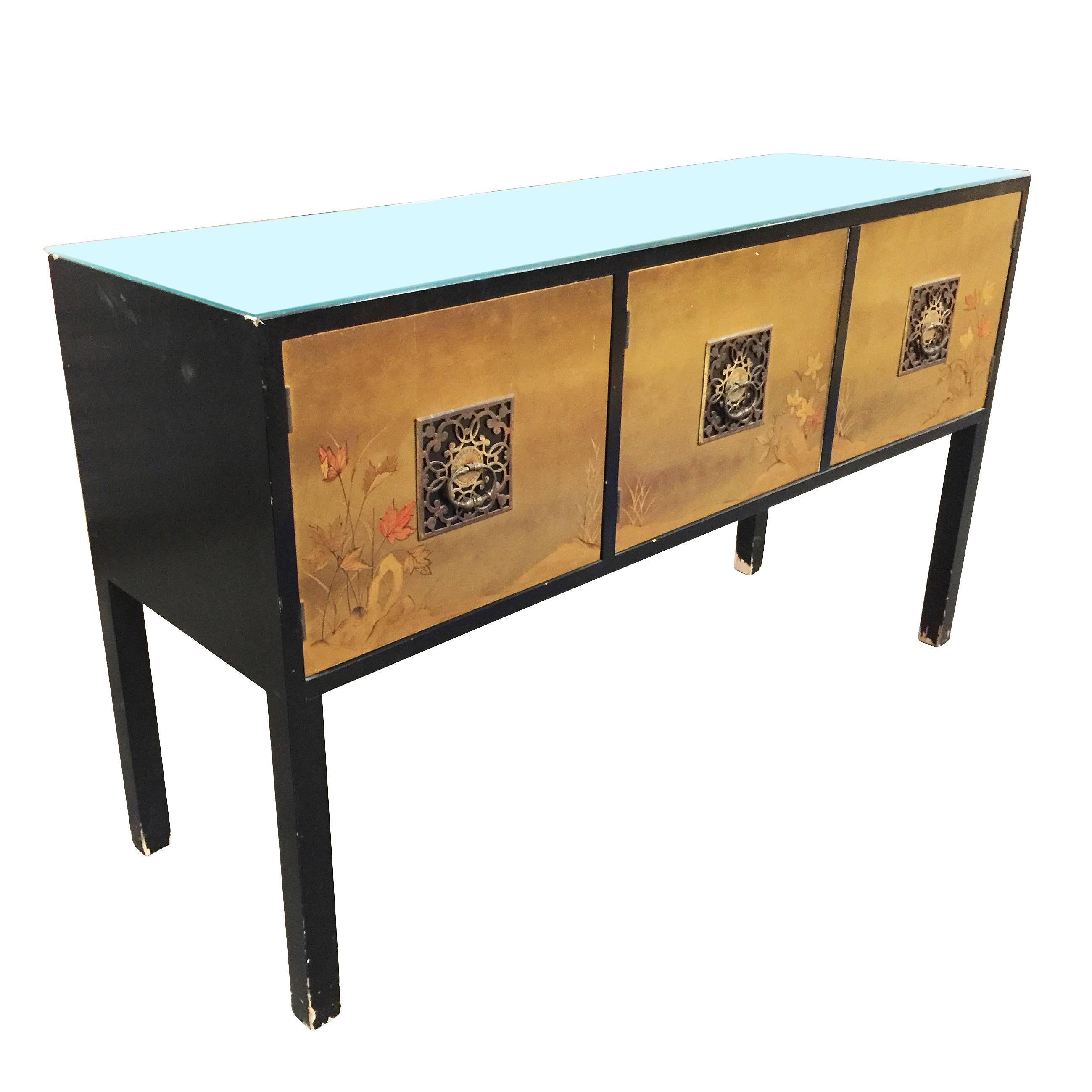 Asian inspired console cabinet with black lacquer body and hand-painted doors and bronze pulls along the front. The form and styling were inspired by the Asian influenced midcentury styling made famous by James Mont. 

The cabinet features three