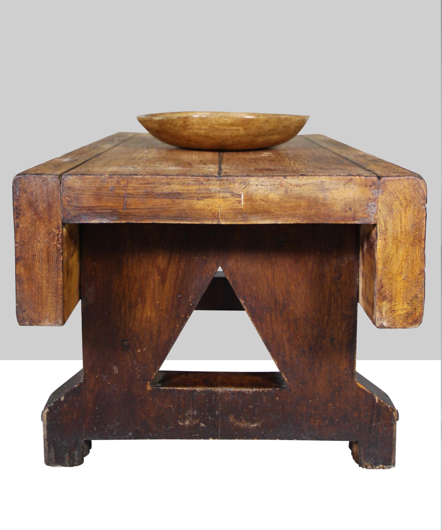 Heavy pine table with original metal bolts and triangular cut outs.

 