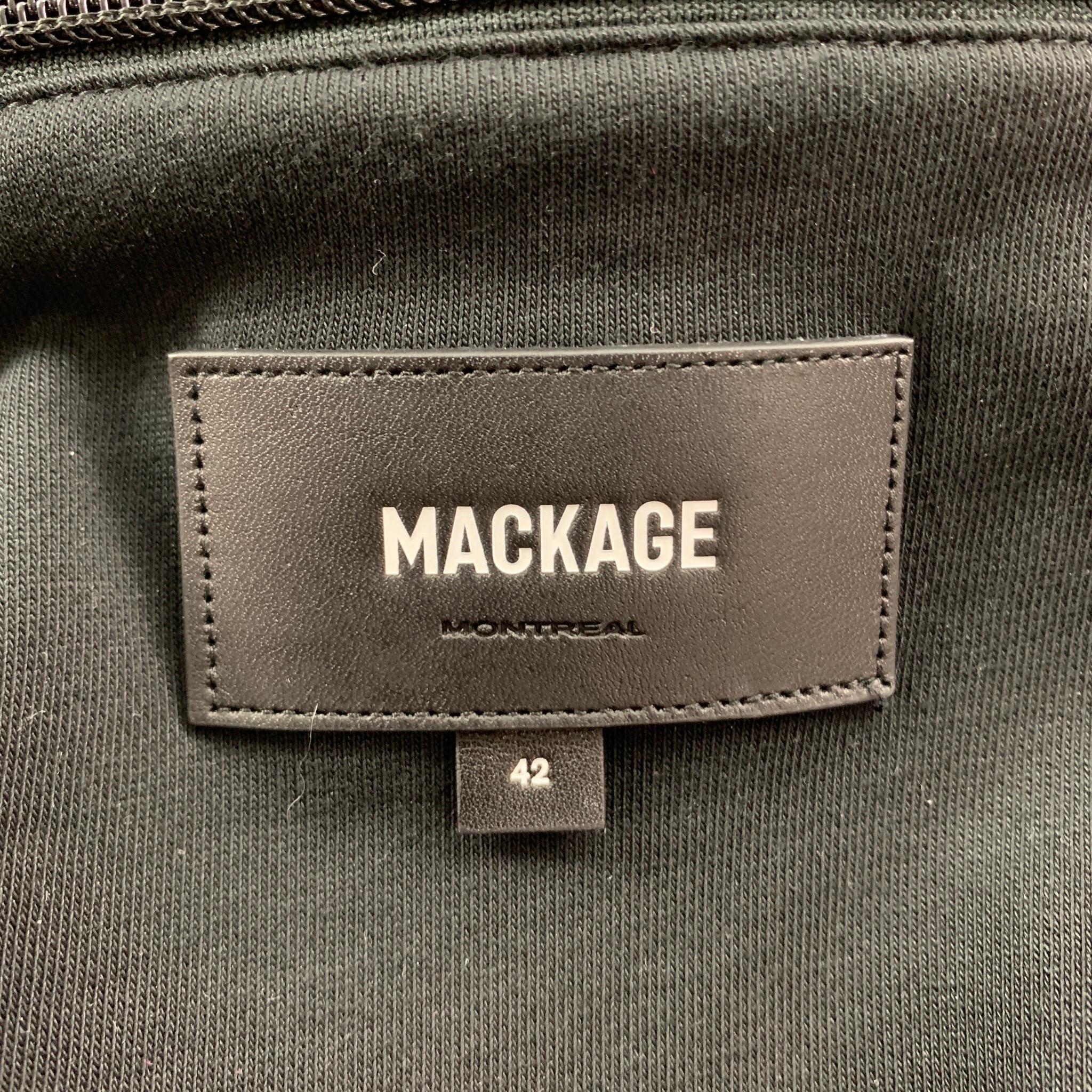 MACKAGE jacket comes in a black polyester featuring a hooded style, detachable layer, ribbed hem, front pockets, and a zip up closure. 

Very Good Pre-Owned Condition.
Marked: 42

Measurements:

Shoulder: 20 in.
Chest: 42 in.
Sleeve: 27 in.
Length: