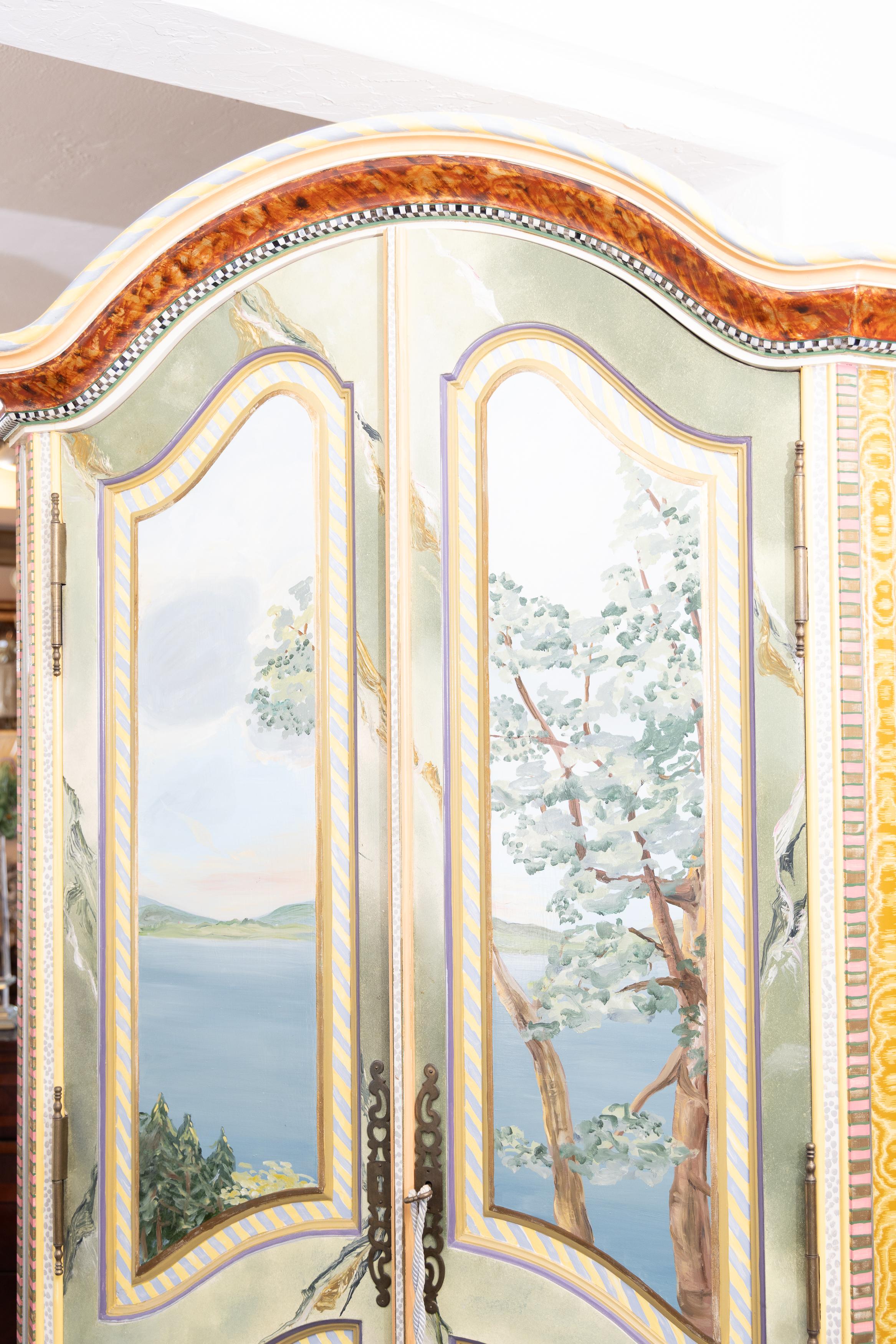 This is an exquisitely painted wardrobe by Mackenzie-Childs. The domed cornice is situated over two long arched doors artistically painted depicting a natural landscape motif. The sides are painted in a romantic profusion of floral sprays. Other
