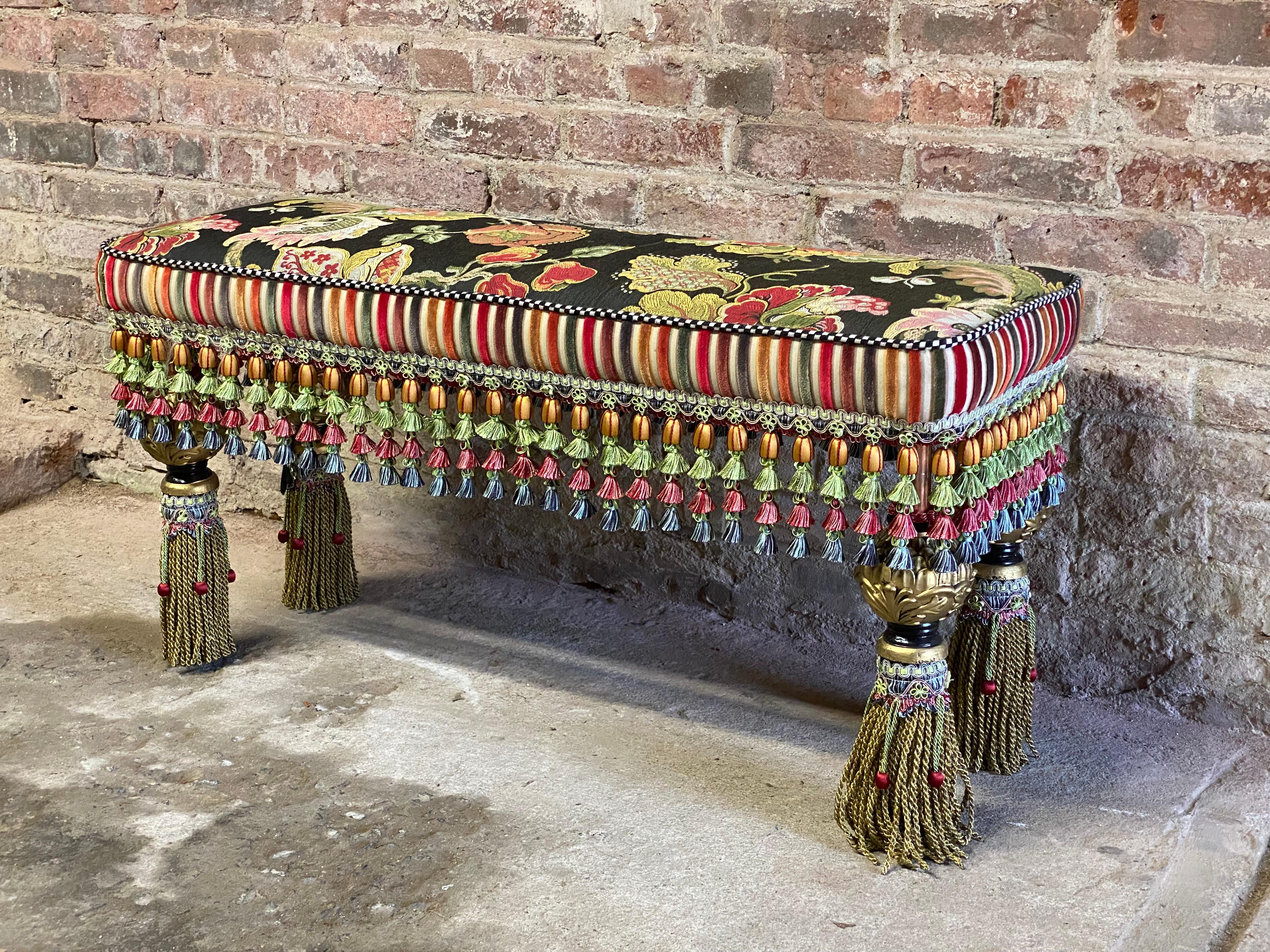 Signed Mackenzie Childs upholstered bench. Fantastically bizarre and whimsical piece that could go anywhere in the home or office. The diverse use of pattern, texture, color and design make her pieces stand out. Circa 1990. Good clean overall