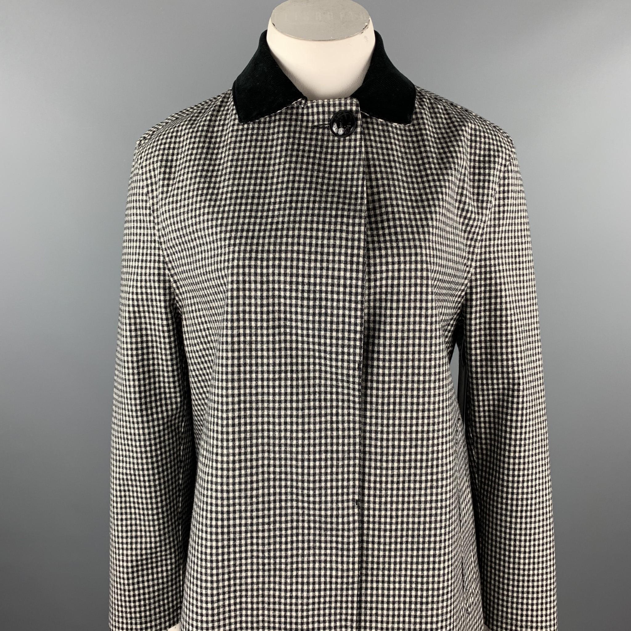 MACKINTOSH coat comes in a black & white checkered wool with a red window pane liner featuring a corduroy collar, underarm grommet holes, and a hidden button closure. Handmade.

Excellent Pre-Owned Condition.
Marked: No size
