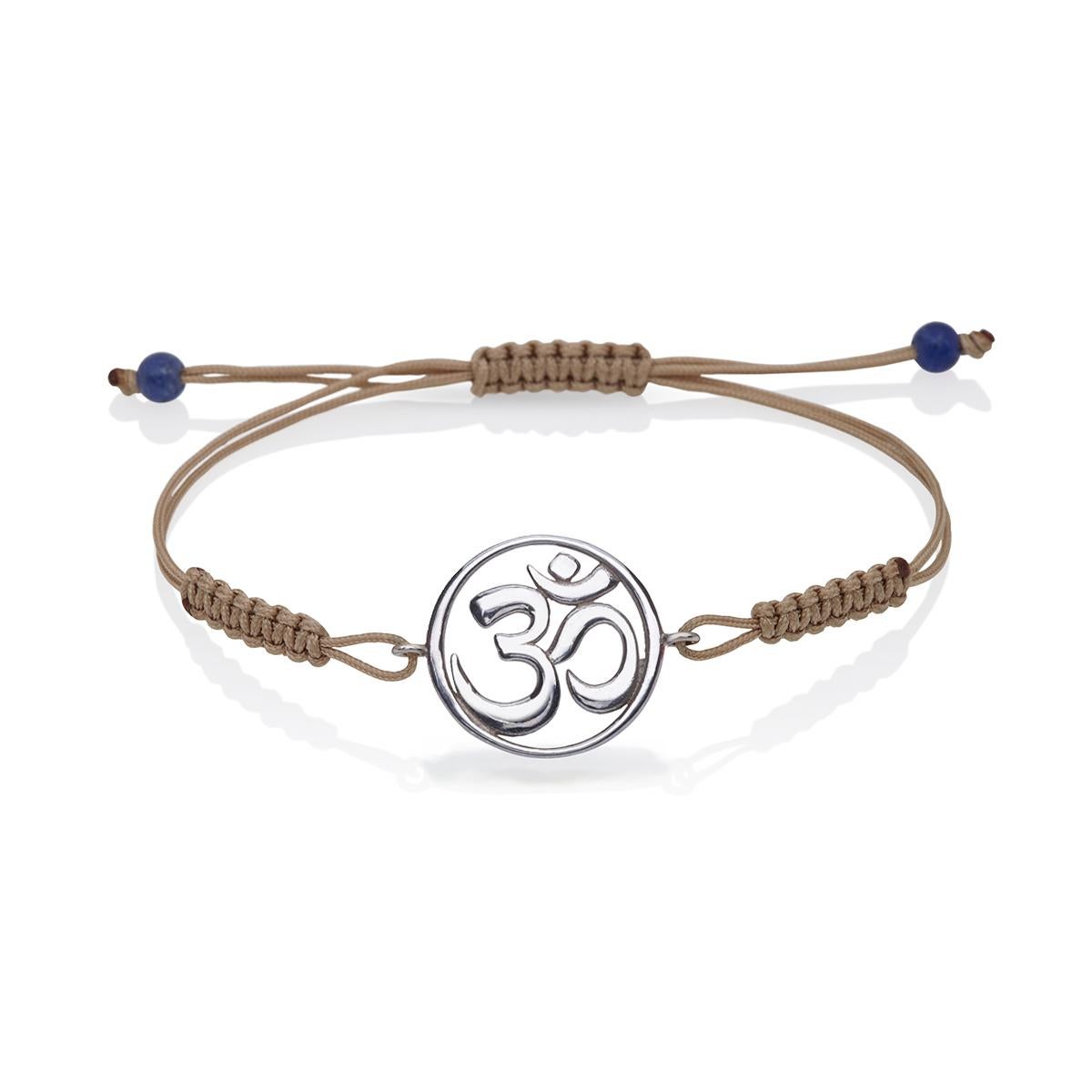 Macrame Bracelet with the Om Symbol in 14Kt white Gold with Colored brown Cord and lapis lazuli Gift for Her.
A very beautiful and wearable macrame bracelet made of 14Kt Gold with the Om Symbol. It will match with everything in your closet. Designed