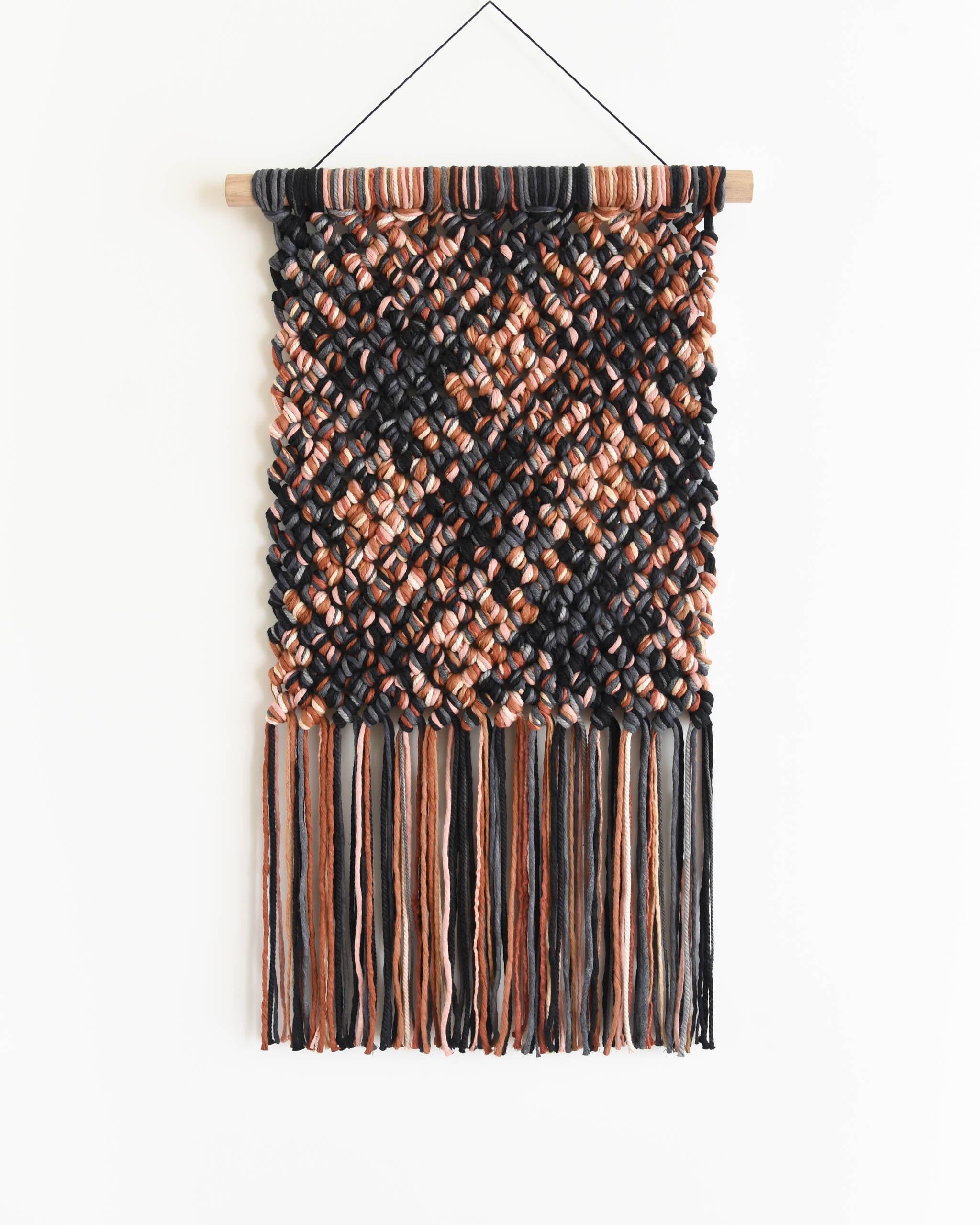 PINGUIA - a series of 10 unique, chunky, colorful tapestries. Bold in form and playful in color, each work has its own character and energy.

Pinguia #2 is a fiber art piece in black, grey, terracotta and blush tones, with a chunky, tactile macrame