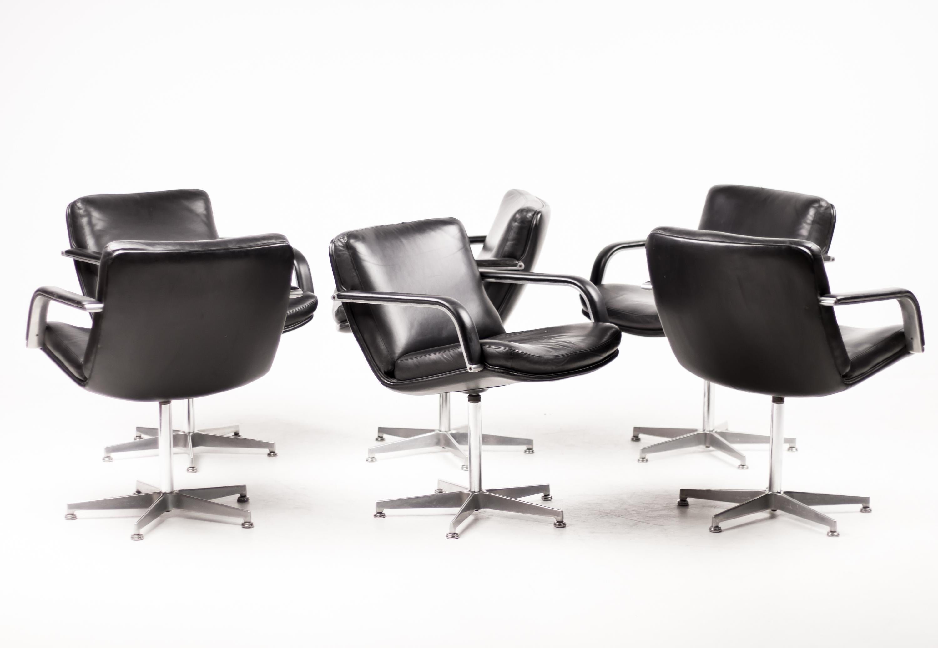 Iconic Artifort 384 chairs from the late 1960s in original black leather. 
Five star swivel base with comfortable armrests.
Marked with Artifort label.

Straight from the boardroom of an illustrious Dutch brewery.
Perfect for a Mad Men interior.