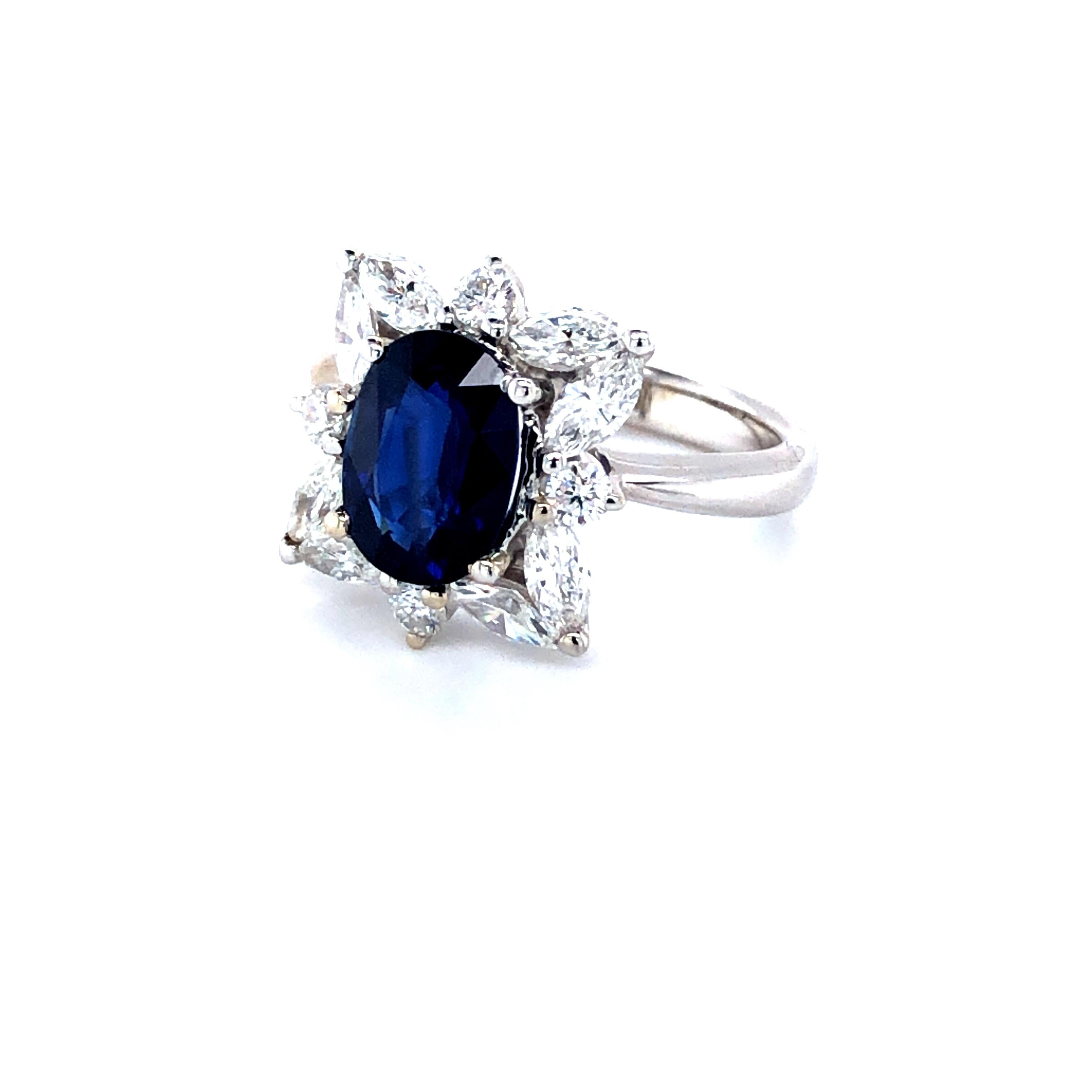 Offered here is an opulent Sapphire and diamond ring in 18kt white gold, circa late last century, in pristine condition. 
Featuring one natural earth mined blue Sapphire, provenance is Madagascar, A.G.L certified to be natural corundum sapphire