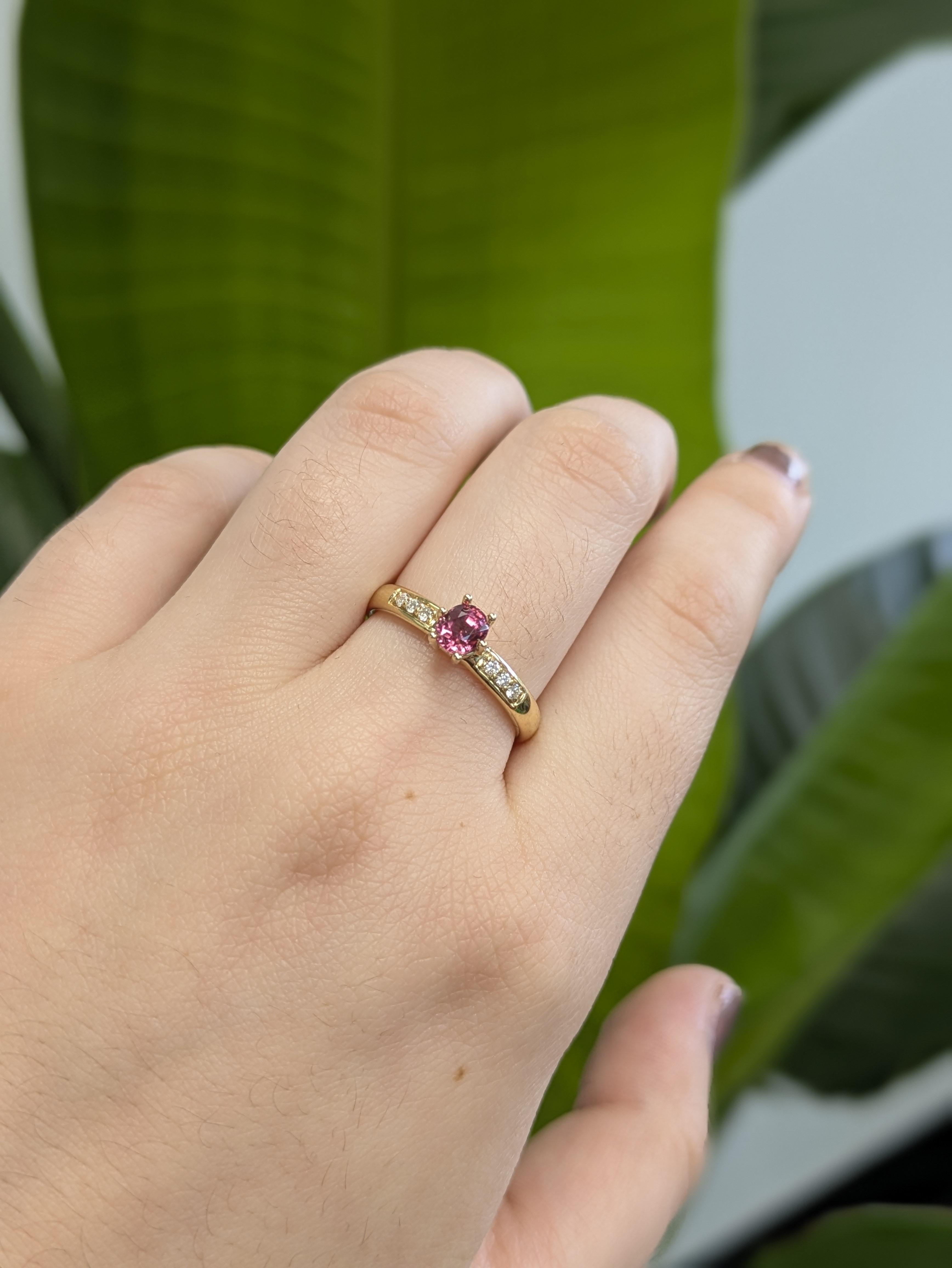 Delicate in hue but bold in design, this untreated 4mm pink spinel is nature’s gem in its purest form. Set with brilliance in a sturdy 6-prong setting and framed by earth-mined diamonds, the rich 14K yellow gold band adds just the right amount of