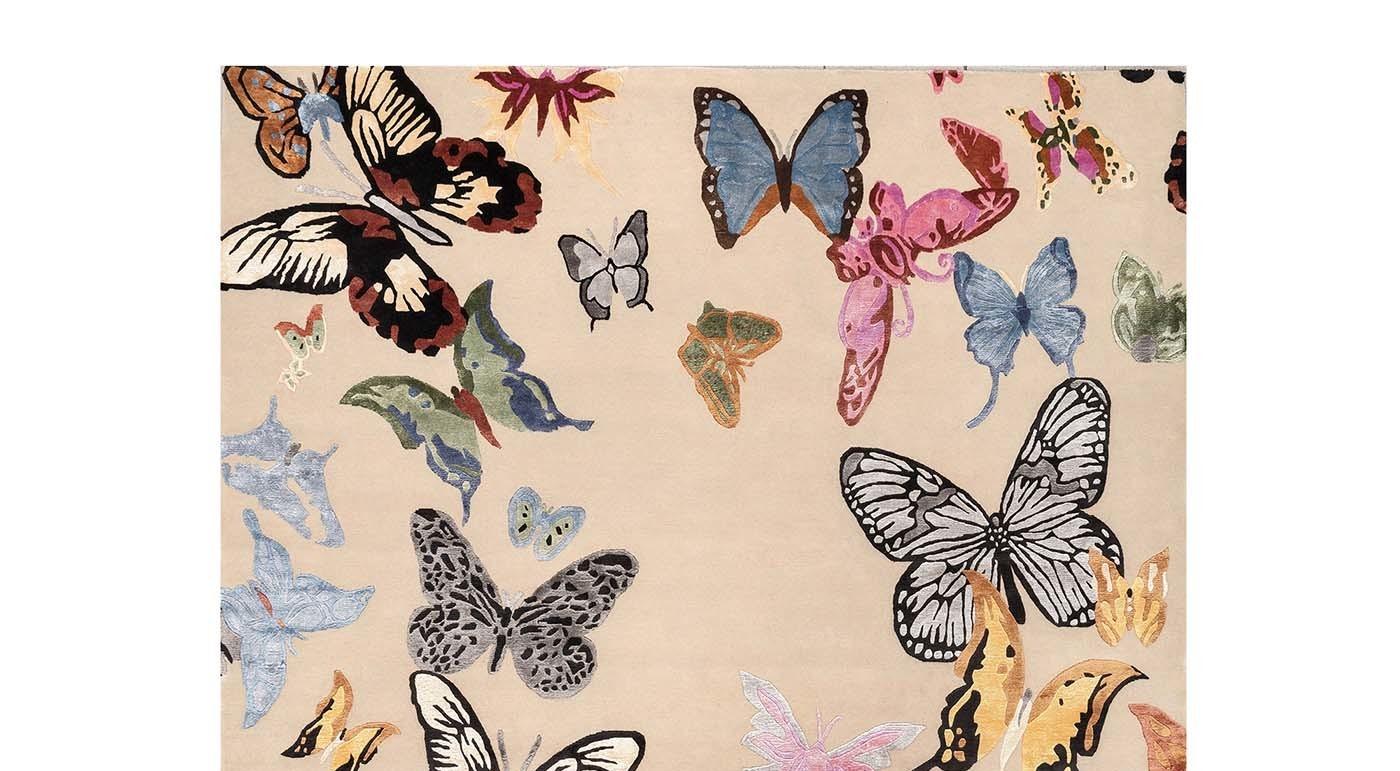 Colorful butterflies fly over a cream-colored background in this superb rug that will add an elegant sense of movement to both a contemporary and a traditional setting. Hand-knotted by master craftsmen in Nepal, this 152,000 knot/sqm piece is