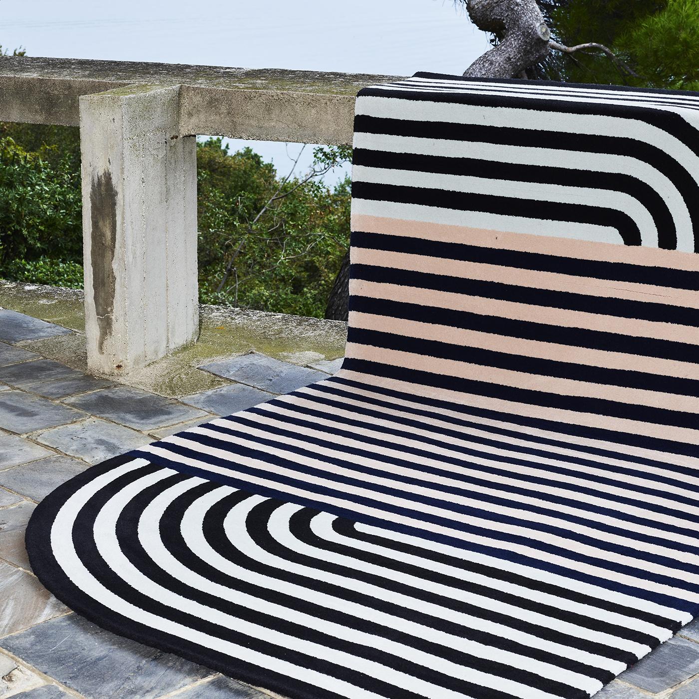 Strong visual allure and a contemporary aesthetic distinguish this stunning rug designed by Alquati+Corso and part of the Roquebrune Collection. Made entirely by hand using virgin wool from New Zealand, the asymmetrical silhouette of this piece is