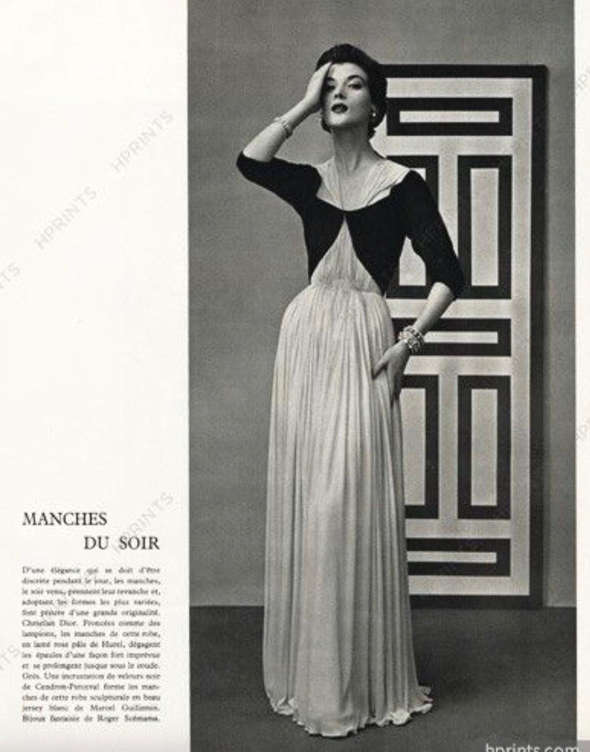 This is a historically significant haute couture gown personally owned by the legendary French designer Madame Grès. Created in 1954, the gown showcases her iconic mastery of draping and pleating, featuring an exquisite combination of a black velvet
